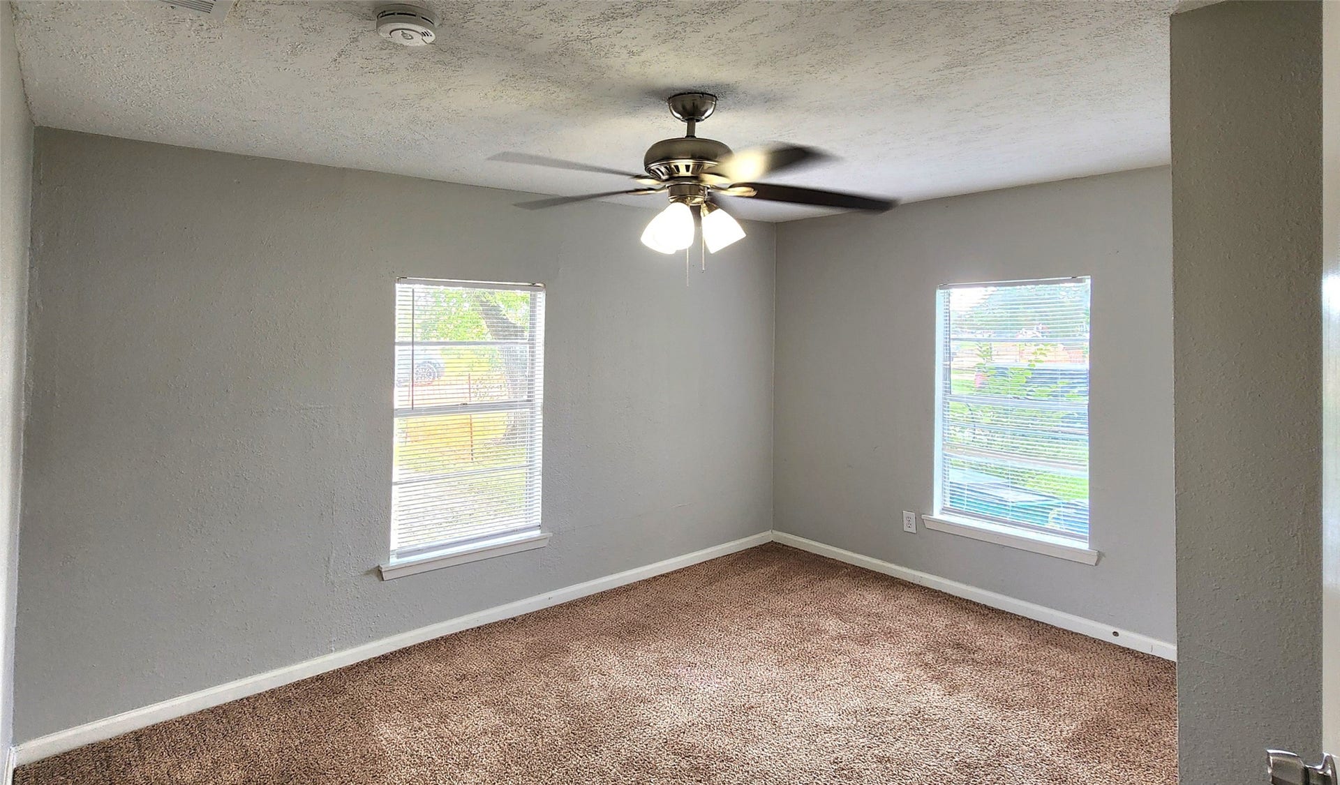 419 N Parrish Street, Angleton, TX 77515 Secondary bedroom with a ceiling fan and two windows.