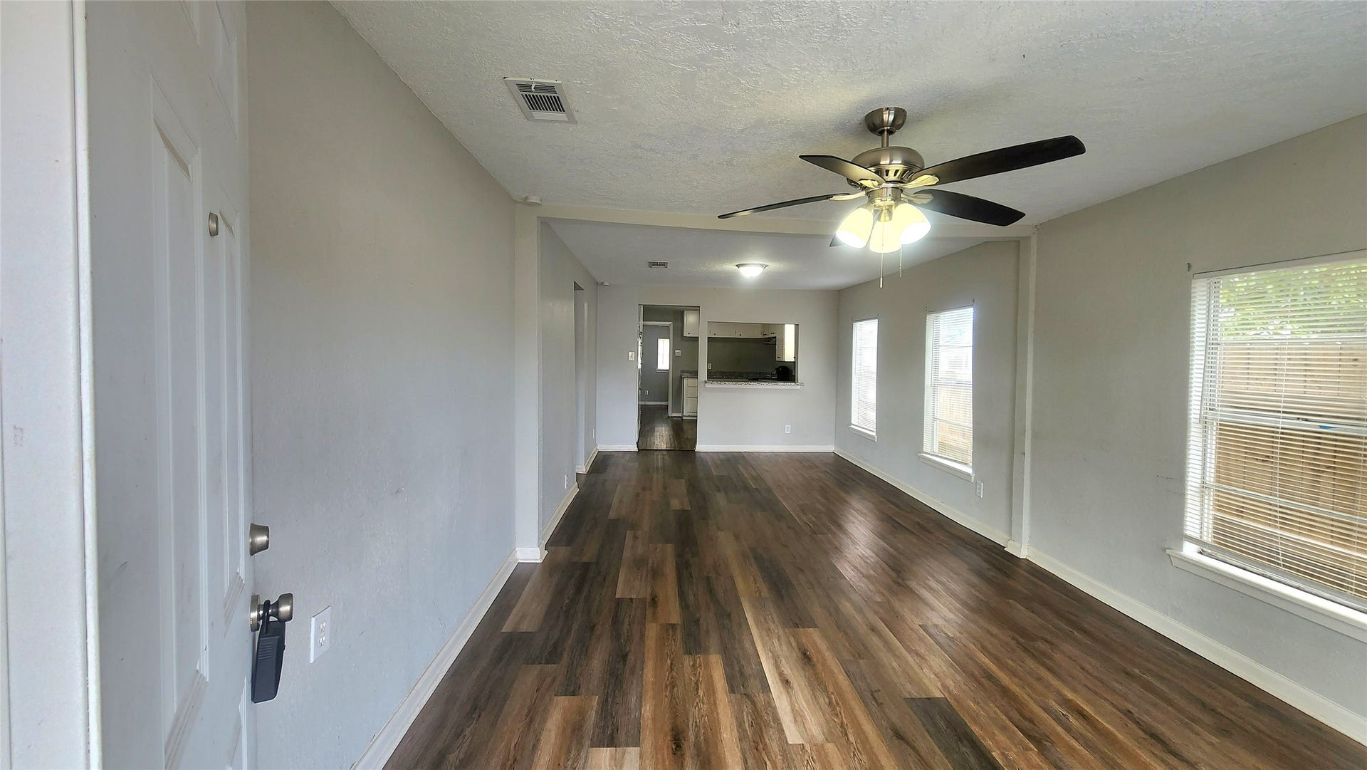 419 N Parrish Street, Angleton, TX 77515 The living room unfurnished, showing the full length of the space and room to arrange your furniture your way.