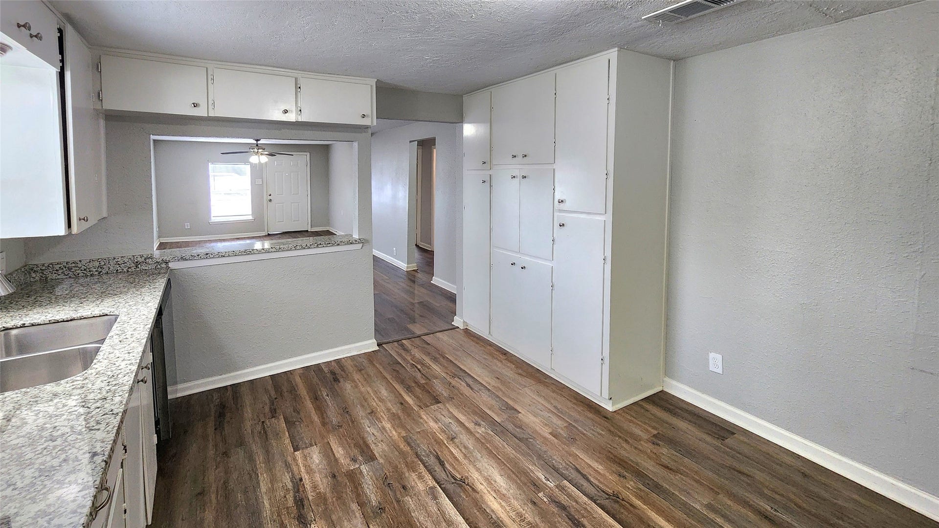 419 N Parrish Street, Angleton, TX 77515 The kitchen flows into the adjoining space, with wood-look floors throughout.