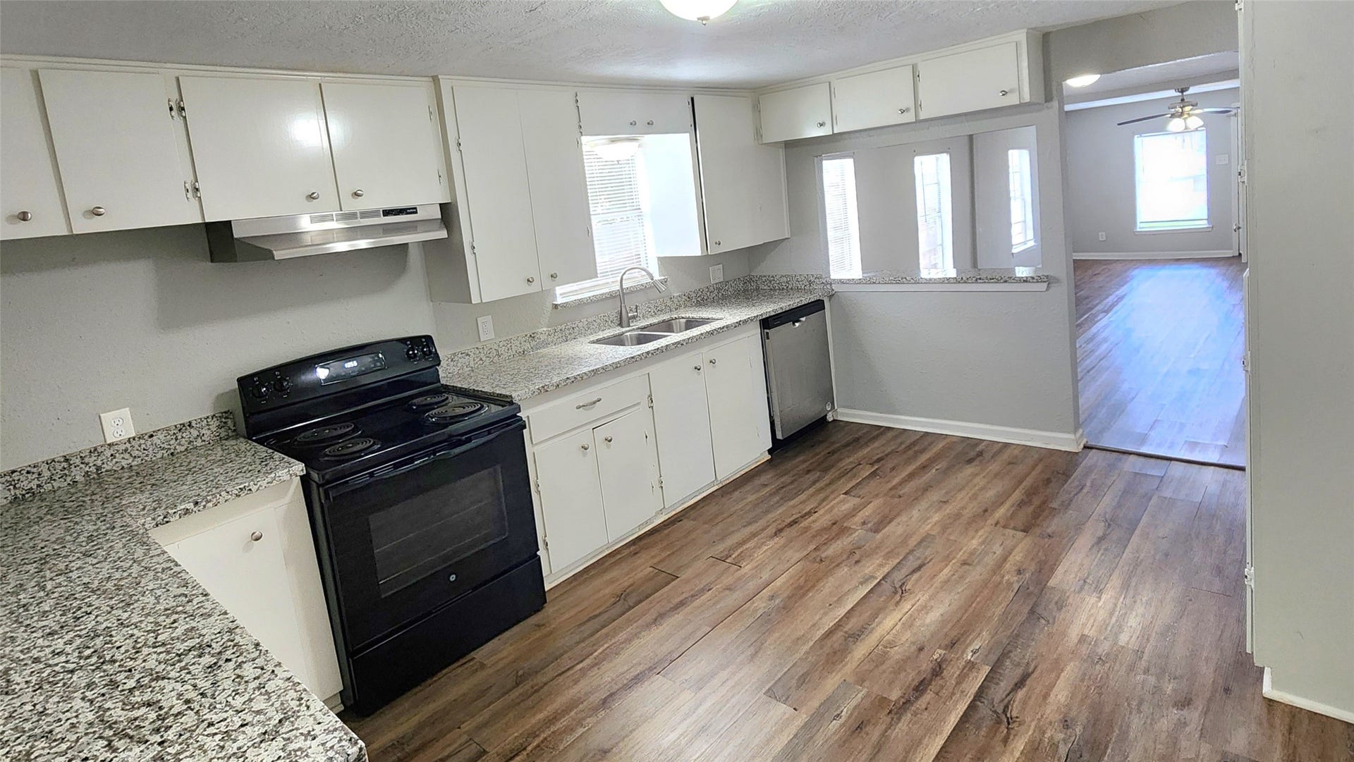 419 N Parrish Street, Angleton, TX 77515 The kitchen opens toward the back of the home, with natural light from multiple windows.