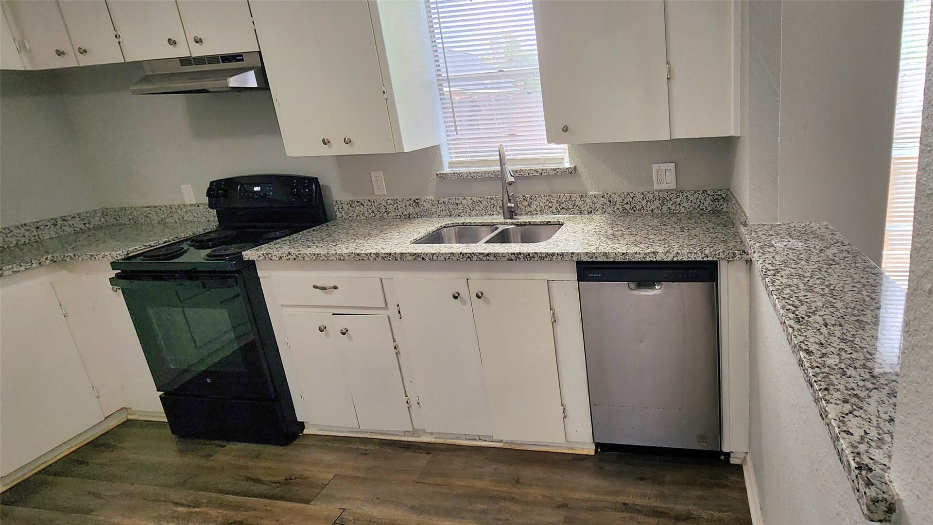 419 N Parrish Street, Angleton, TX 77515 Kitchen with granite counters, white cabinets, electric range, and dishwasher.