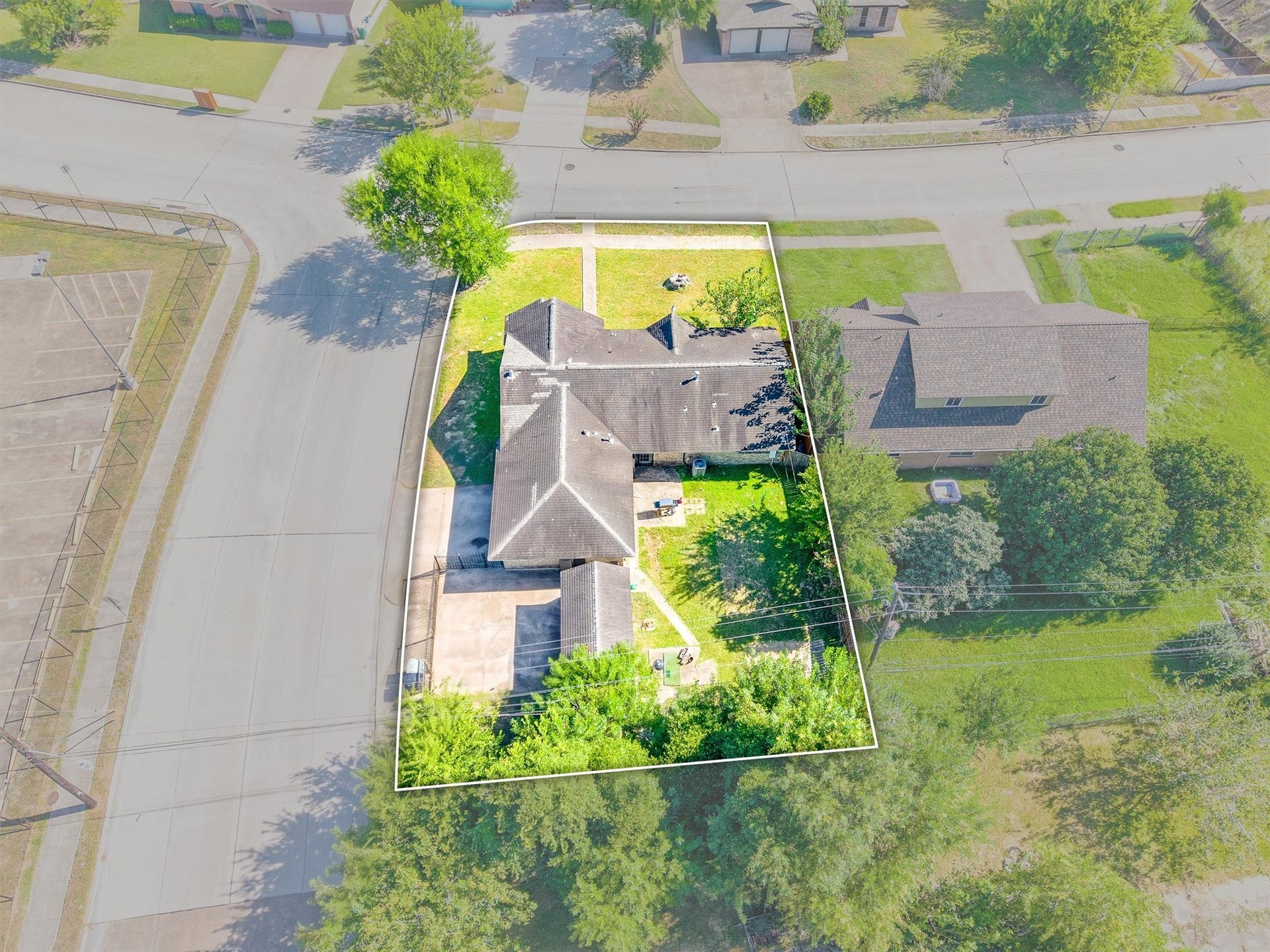 This aerial view highlights the spacious, fully fenced backyard, showcasing the ample outdoor space and privacy the property offers.