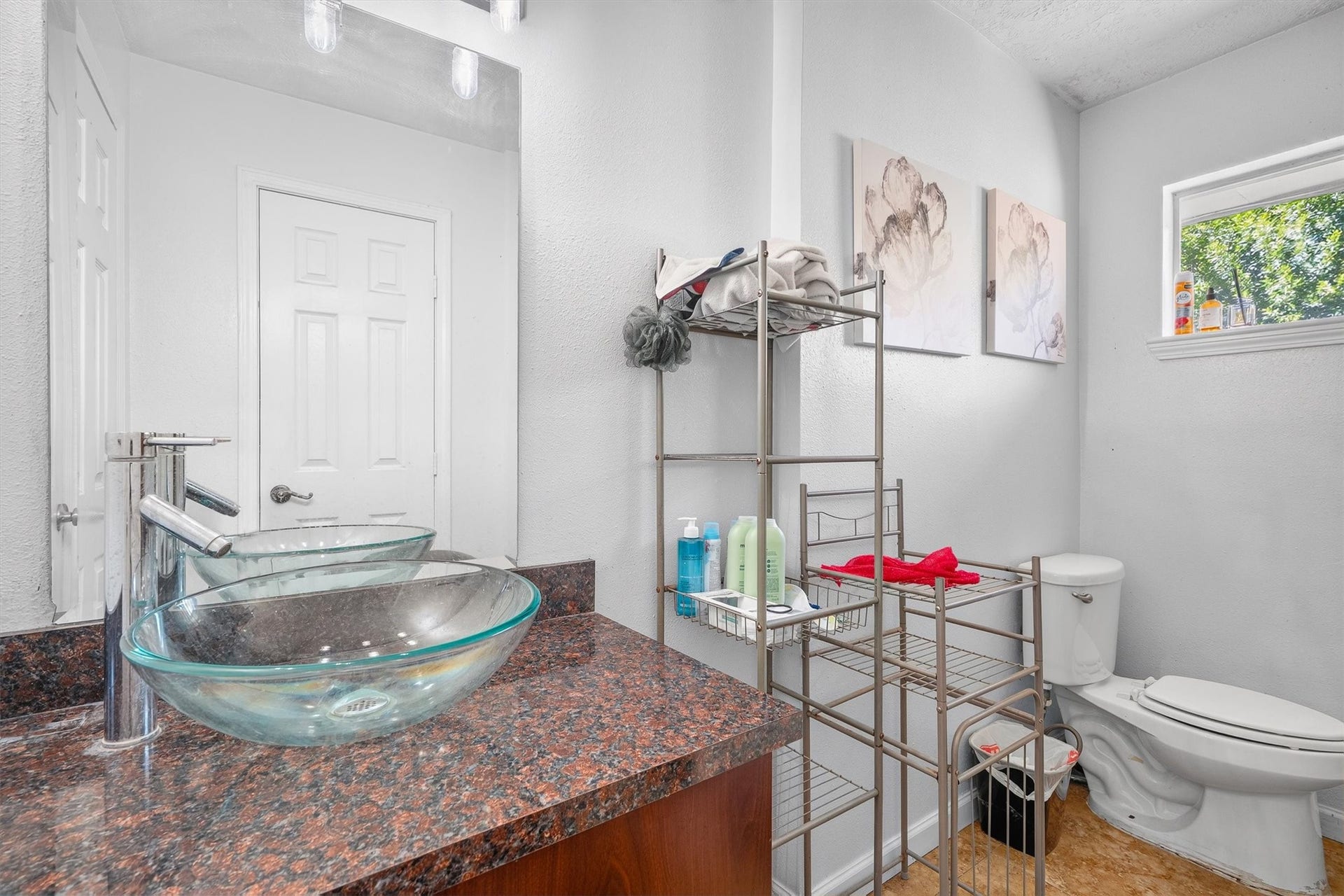 This bathroom features a single-sink vanity, a shower/tub combo, and a toilet  a practical and stylish space designed for everyday comfort.