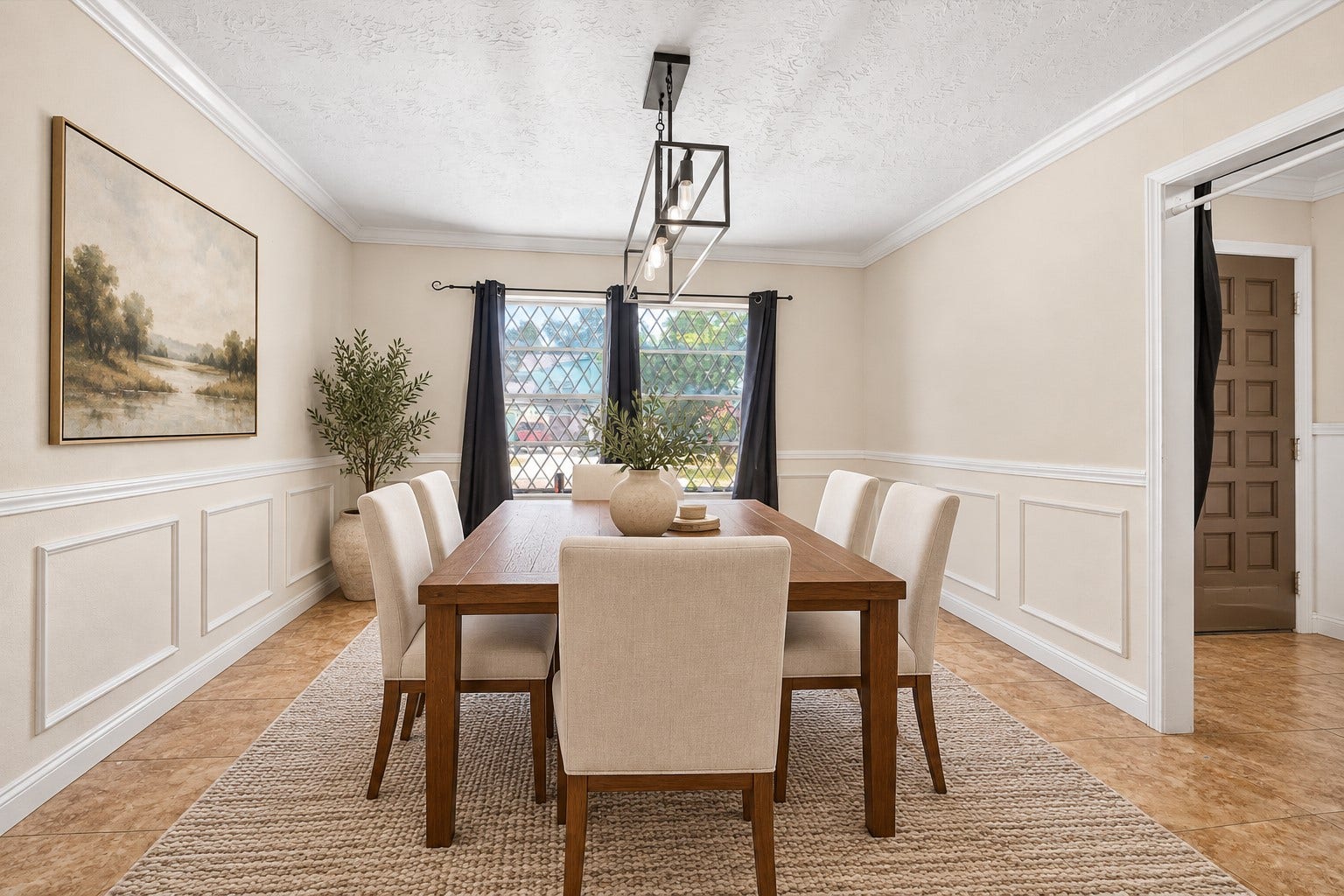 Upon entering, youre greeted by a formal dining room, featuring classic chair molding, a large window and a modern chandeliersetting the tone for this homes thoughtful design. *Virtually Staged