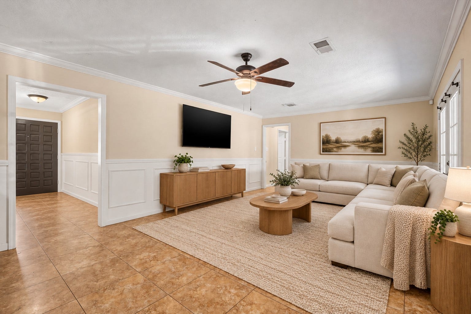 Enjoy a spacious living room featuring sleek tile flooring, sun-filled windows, and a ceiling fan for year-round comfort a stunning space that blends elegance, comfort, and architectural drama. *Virtually Staged