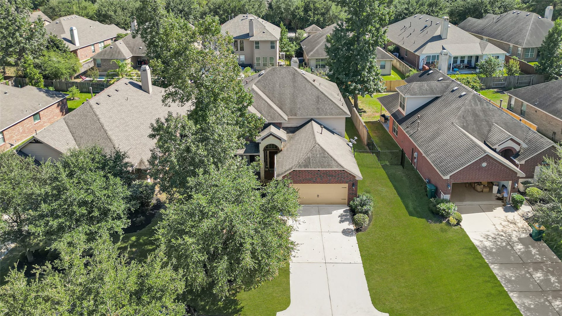 Aerial view shows the lush green trees in the front of the home.