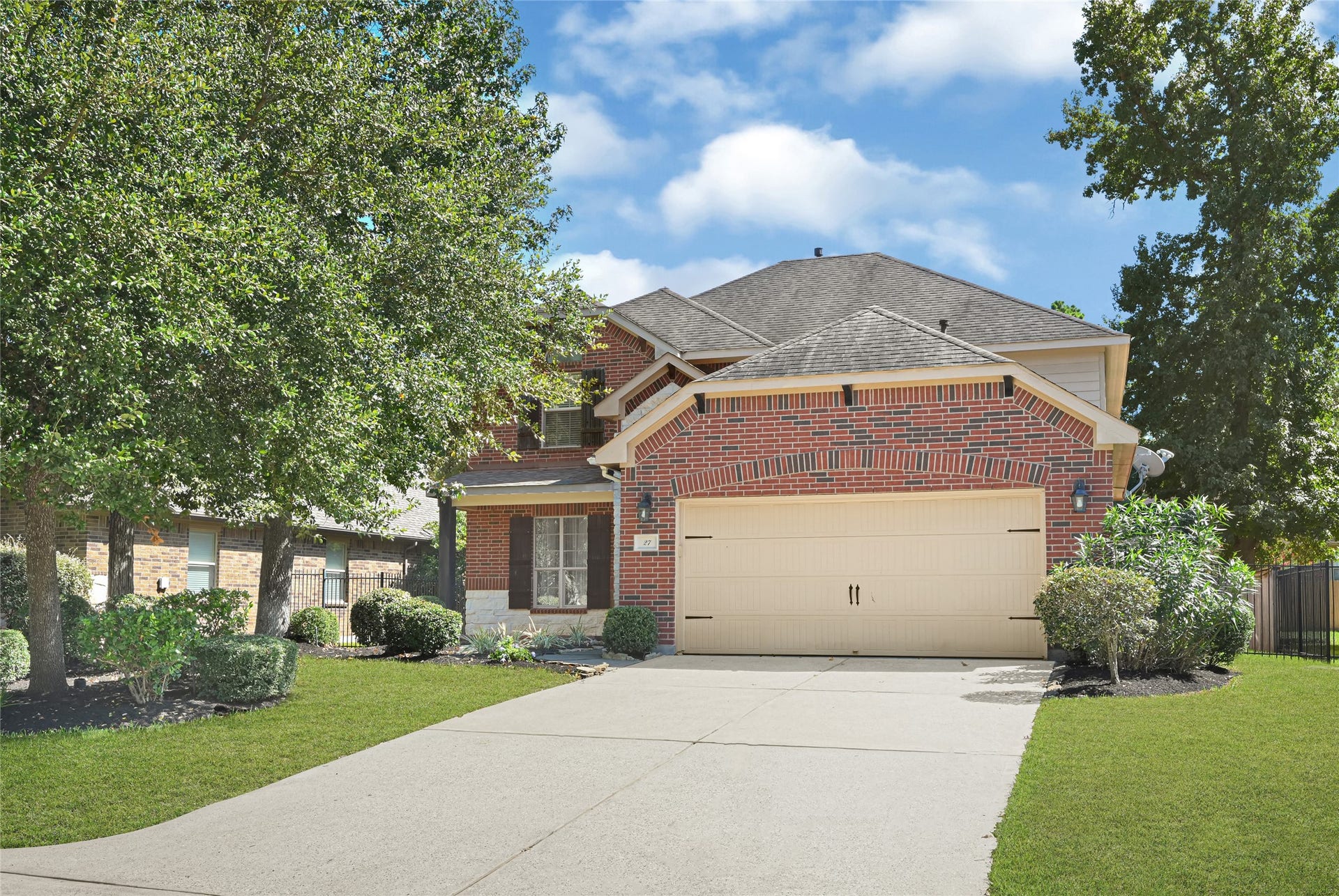 Long driveway, and lush greenery surround the home