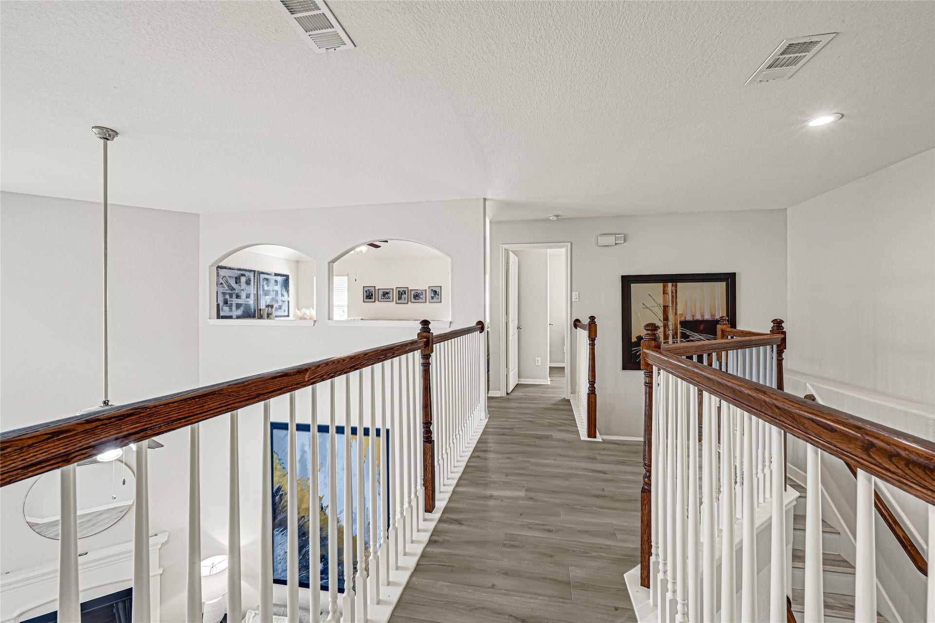 Upstairs hallway with overlook into the foyer and the living room