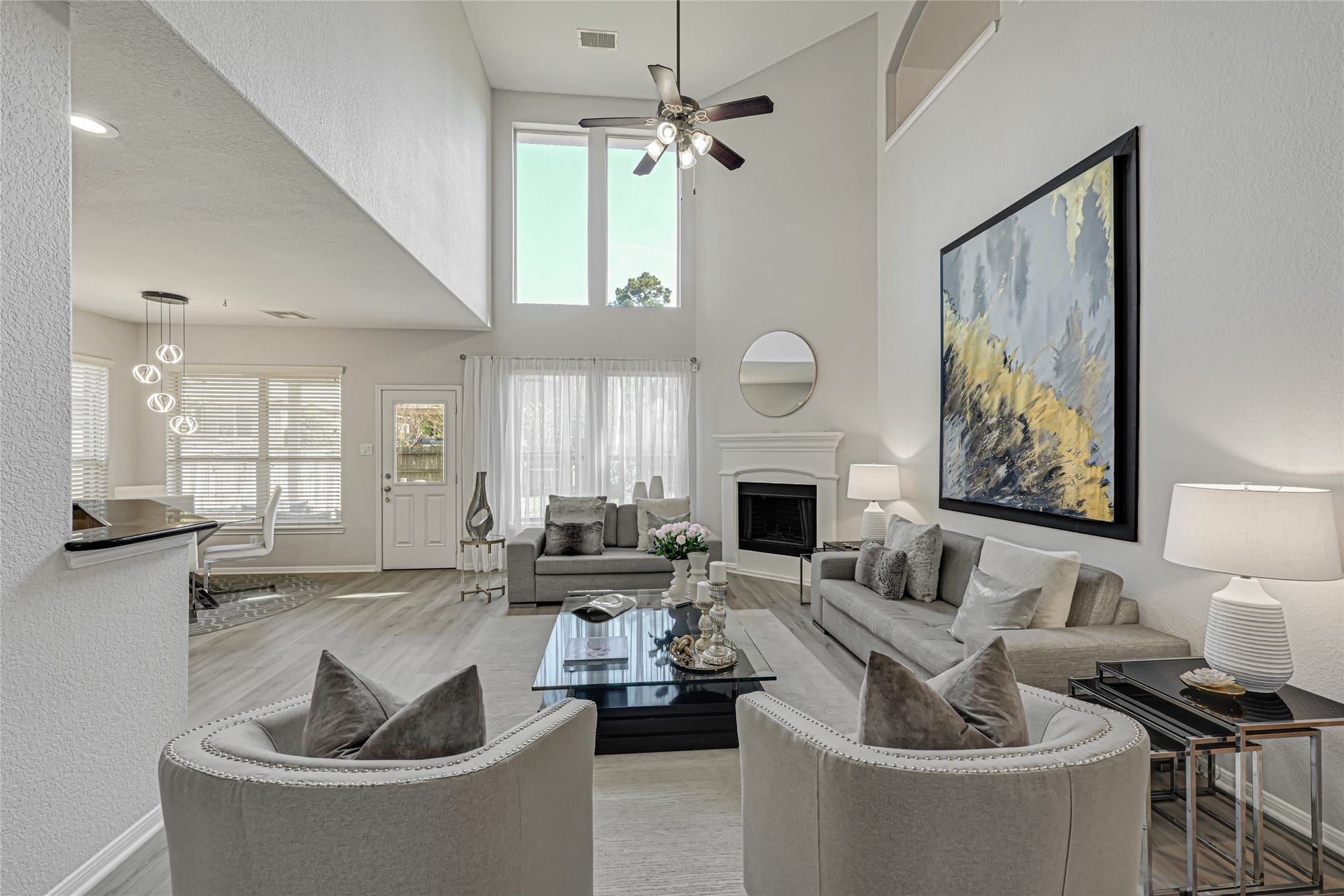 Large 2 story living room with room for plenty of seating. Lots of natural light in the home.