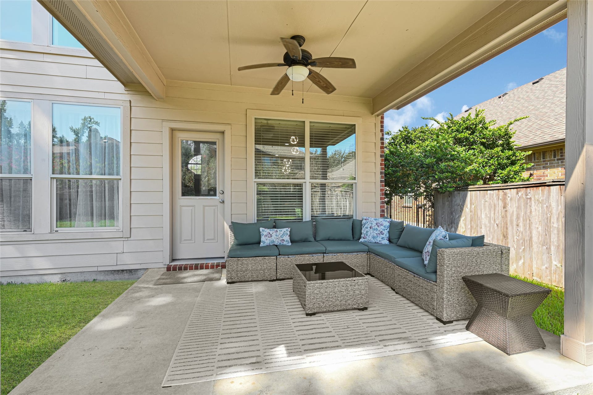 Covered patio space overlooking the large backyard.