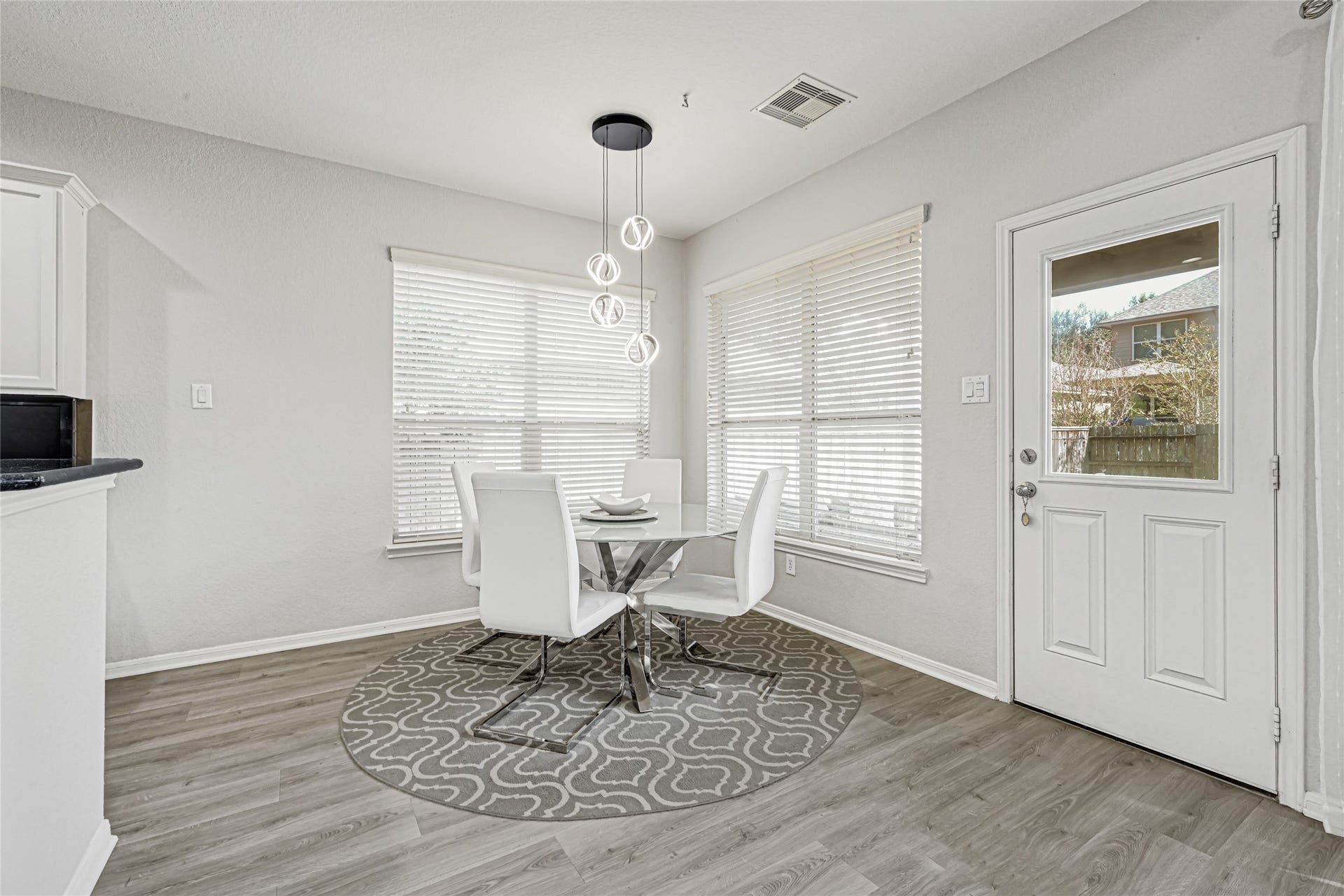 Breakfast area with windows that look out into the backyard.