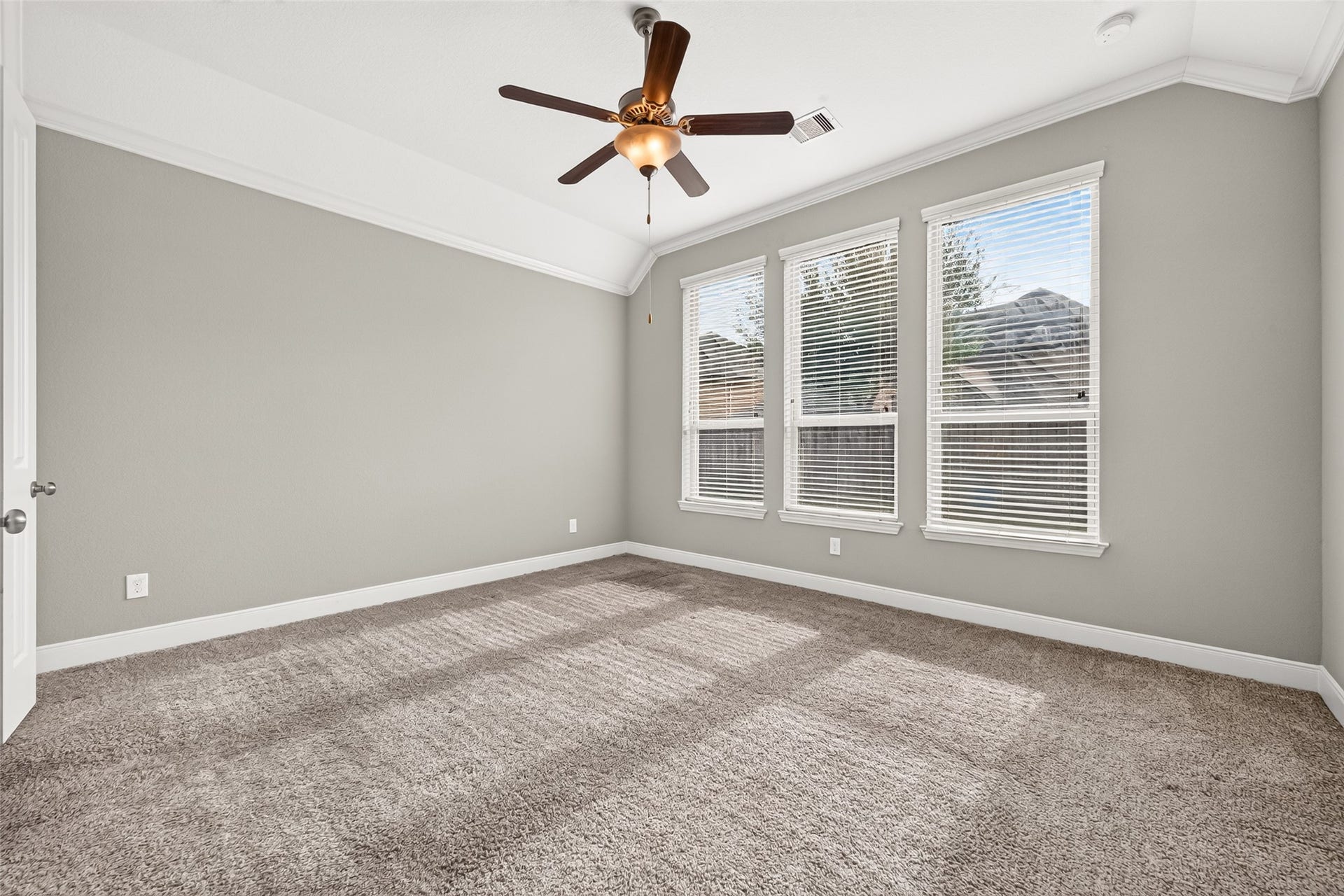 The private primary suite is located at the back of the home and features a wall of windows with high ceilings!