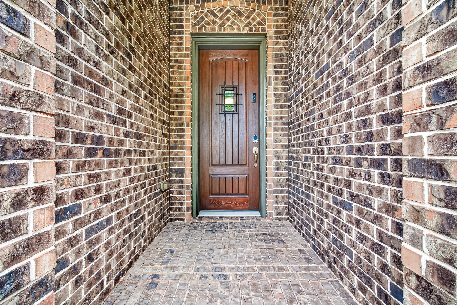 The stunning stone and brick elevation, welcoming covered front porch, and impressive 8-foot wood entry door with iron detailing create wonderful curb appeal.