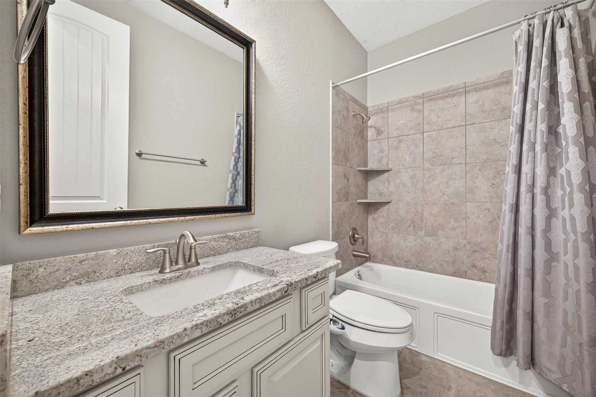 2 additional full bathrooms (1 of 2) featuring granite countertops and shower/tub combinations.