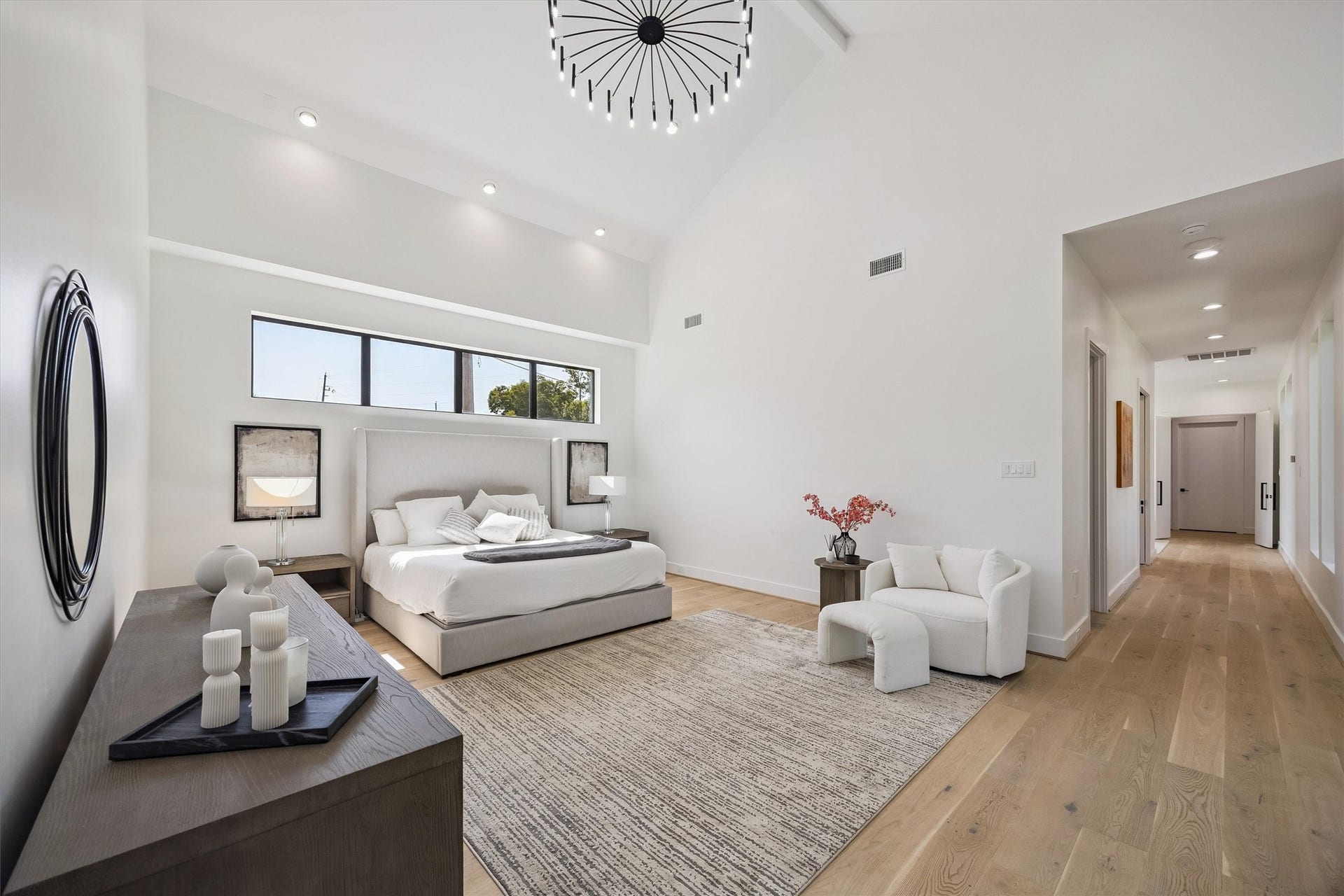 5210 Manor Drive, Sugar Land, TX 77479 Spacious and modern bedroom featuring high ceilings, sleek lighting, and elegant decor, offering a tranquil and stylish retreat.