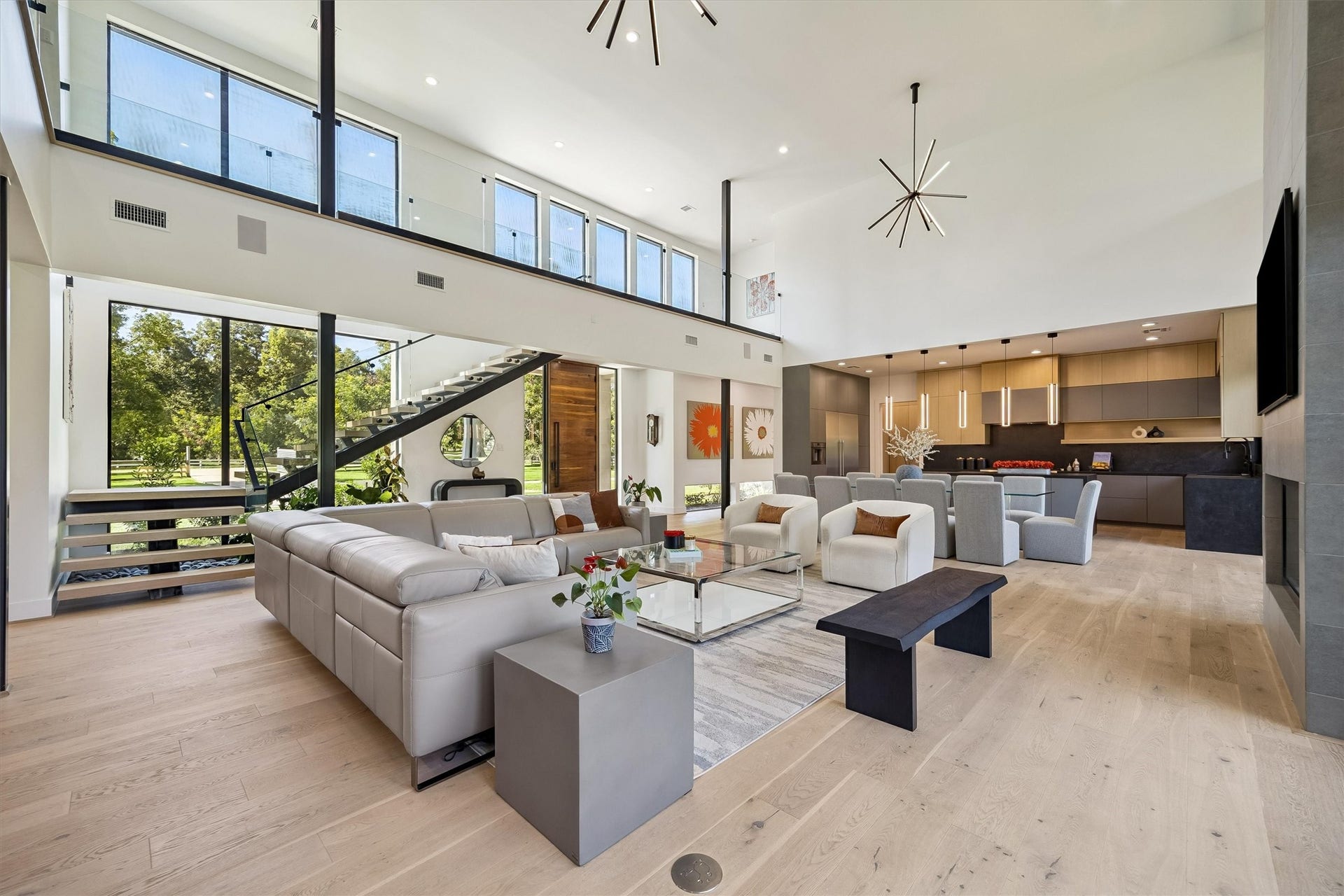 5210 Manor Drive, Sugar Land, TX 77479 Experience modern elegance in this open-concept living area featuring soaring ceilings, sleek finishes, and abundant natural light. The spacious layout seamlessly integrates the stylish kitchen, inviting living room, and dining space, perfect for entertaining.