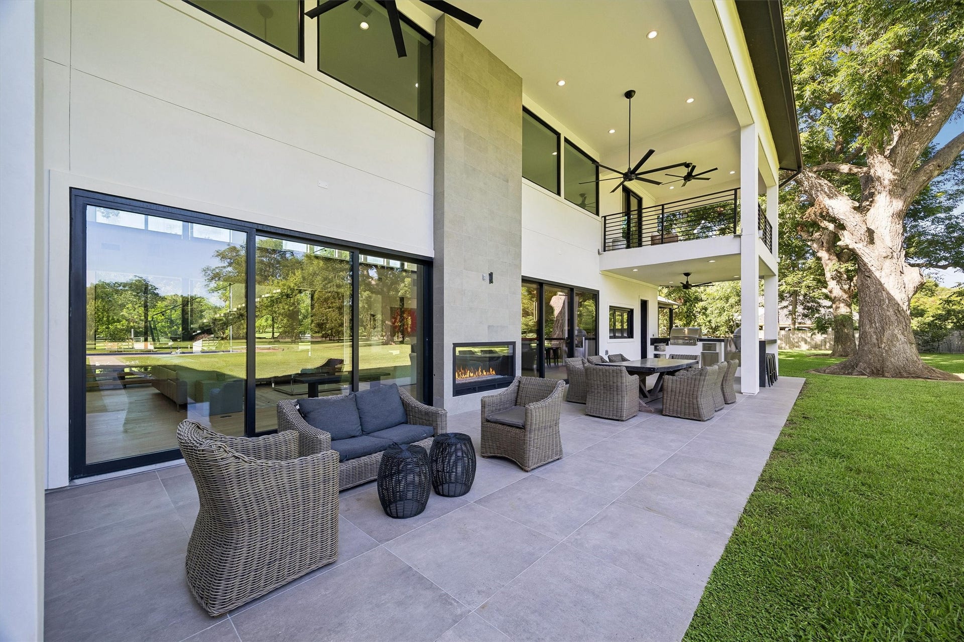5210 Manor Drive, Sugar Land, TX 77479 Spacious and elegant outdoor patio featuring comfortable seating, a modern fireplace, and a scenic view, perfect for entertaining or relaxing.