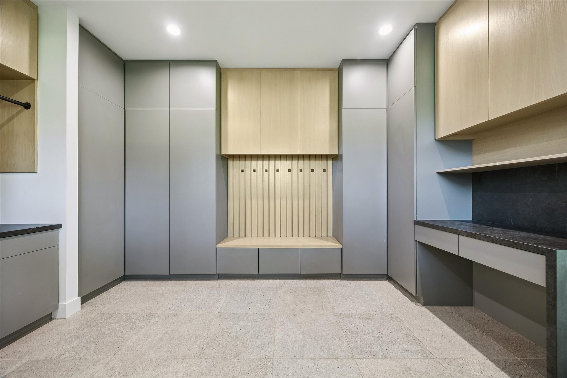 5210 Manor Drive, Sugar Land, TX 77479 Modern mudroom featuring sleek cabinetry, integrated storage solutions, and a convenient built-in bench for organization and style.