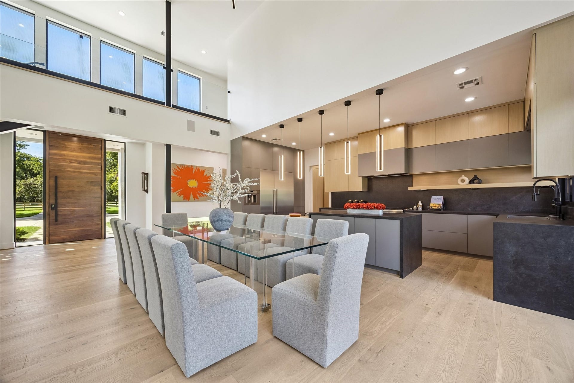 5210 Manor Drive, Sugar Land, TX 77479 Expansive open-concept living area with high ceilings, a sleek modern kitchen, and abundant natural light from large windows, perfect for entertaining.