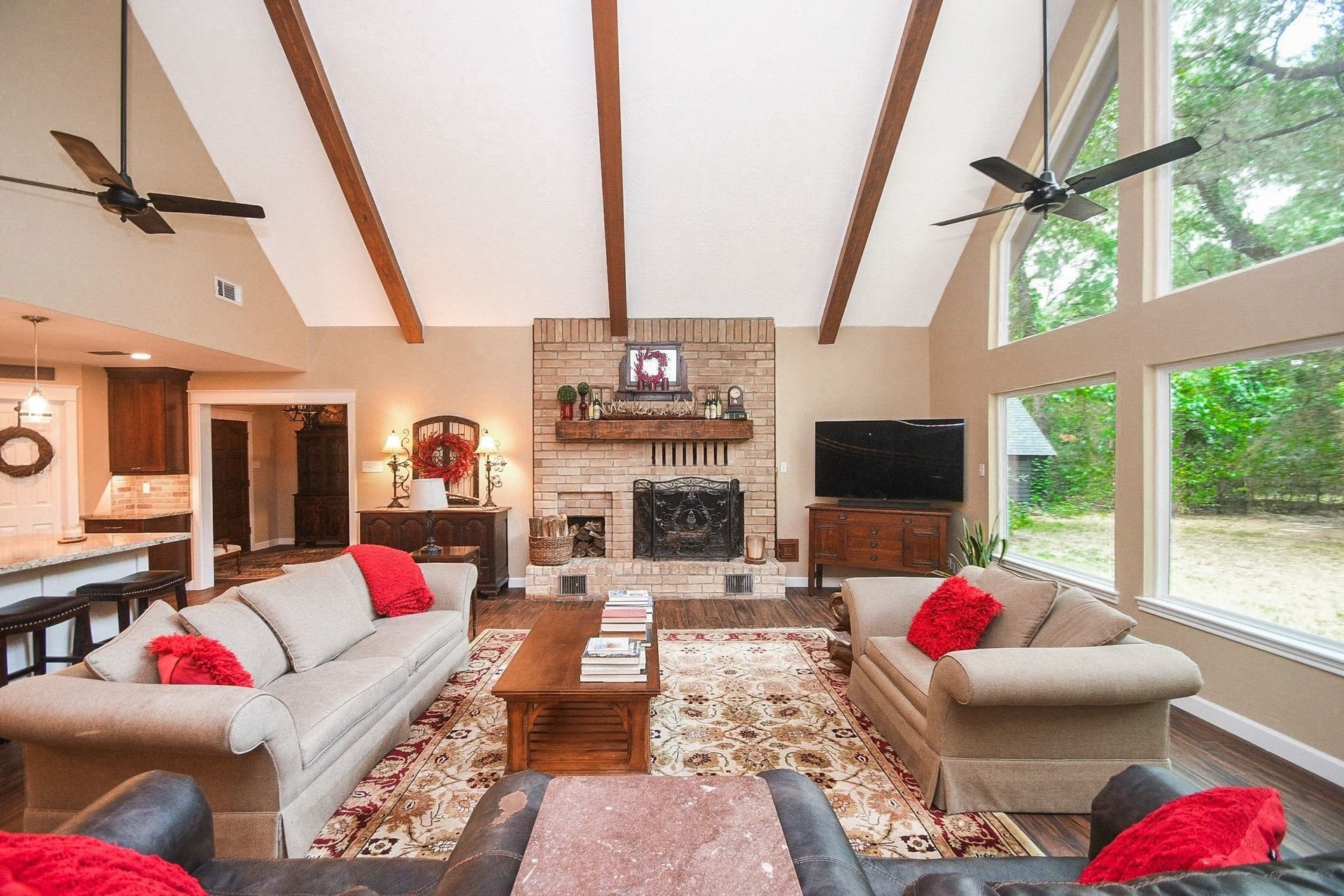 This Beautifully Updated Elegant Brick Home has an Over-Sized Living Area with High Ceilings, 2-Story Windows and a Brick-Faced Wood Burning Fireplace.