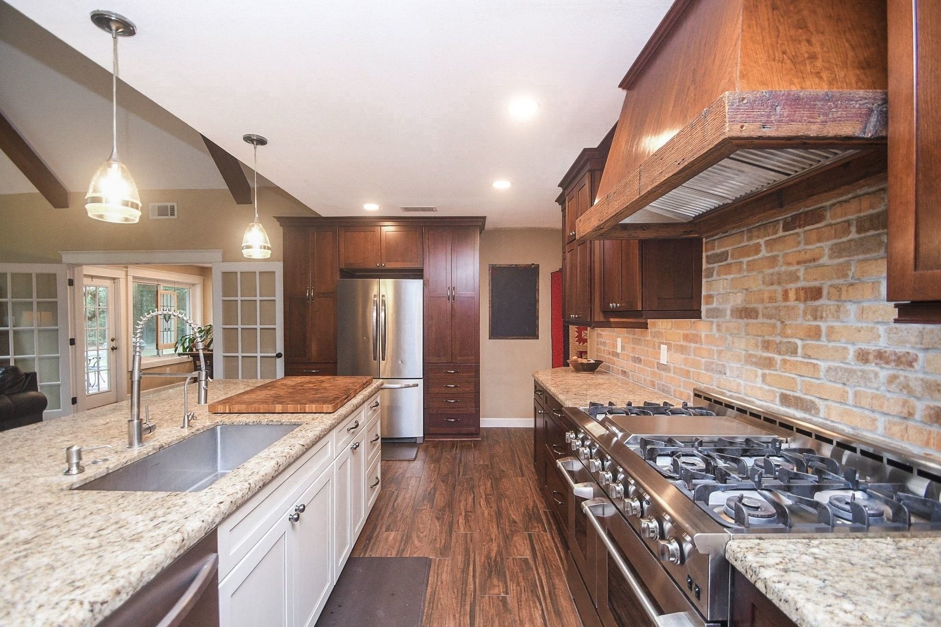 Open Island Kitchen with Custom Cabinets, a Professional NXP Pro 6-Burner Gas Range with Griddle & Large Walk-In Pantry. Large Utility Room.