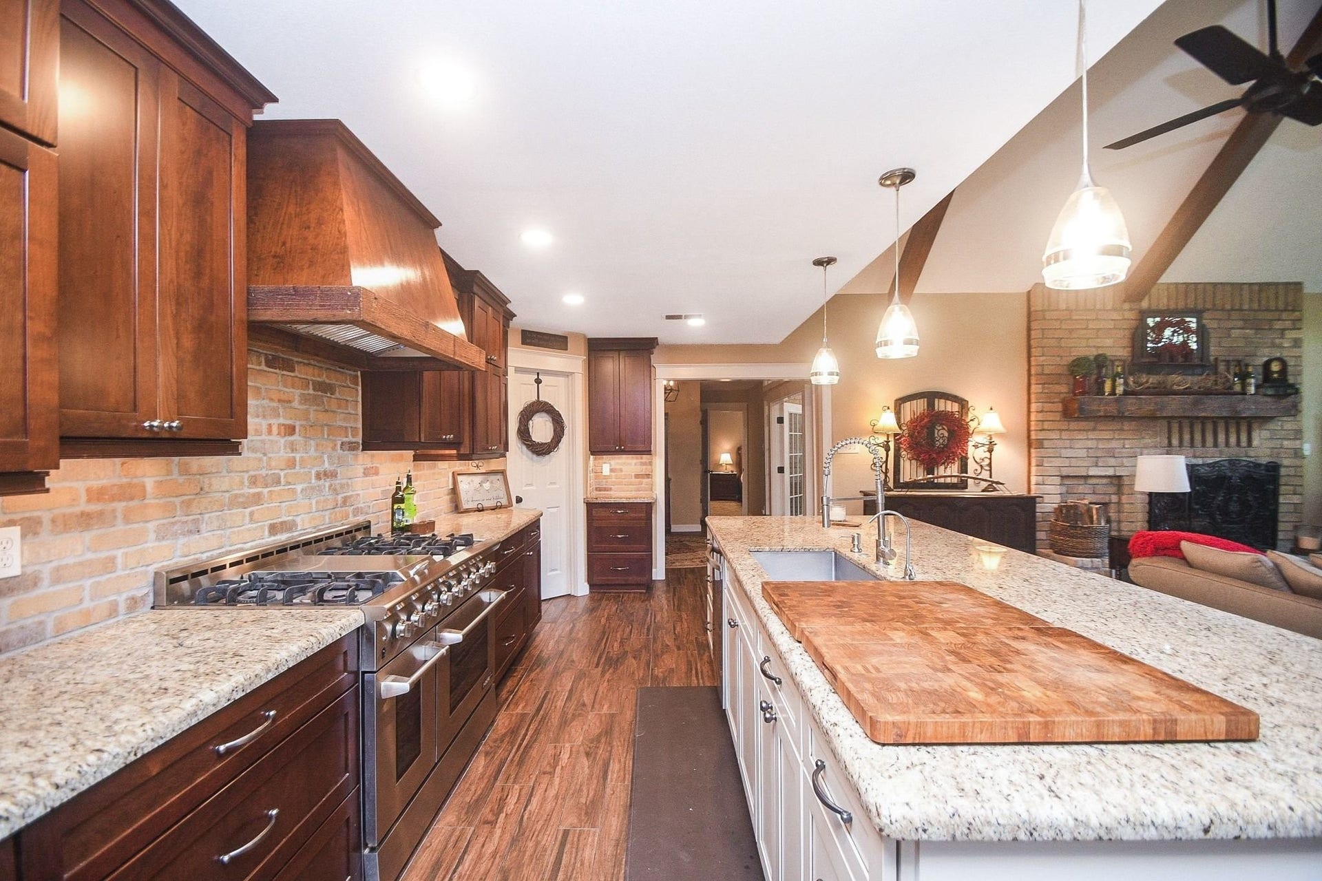Open Island Kitchen with Custom Cabinets, a Professional NXP Pro 6-Burner Gas Range with Griddle & Large Walk-In Pantry. Large Utility Room.