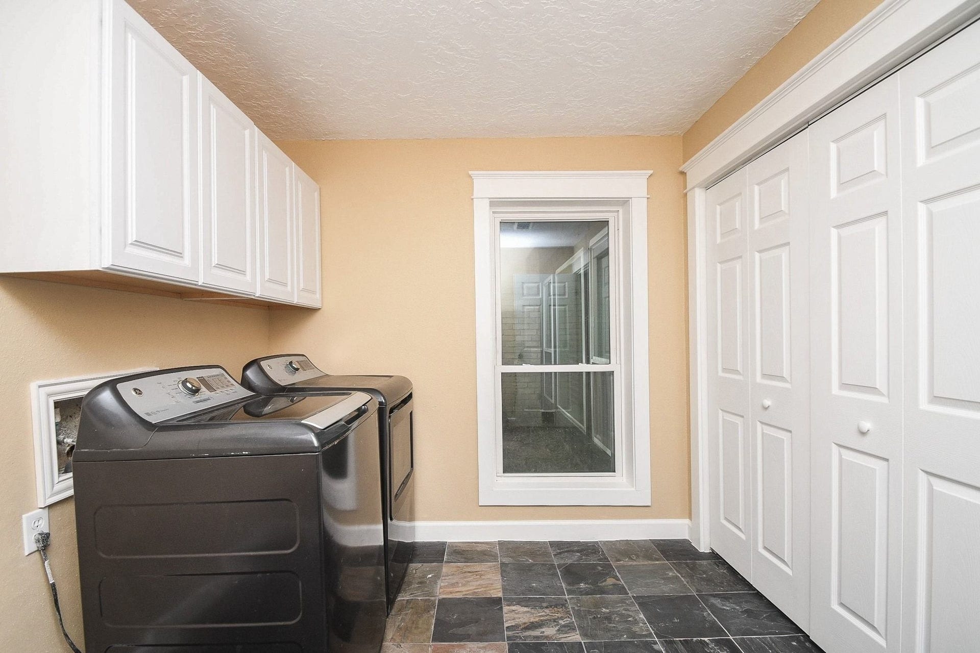 The Utility Room with Built-Ins and a Storage Closet Accommodates a Full-Size Washer & Electric Dryer, plus Room for an Additional Refrigerator/Freezer.