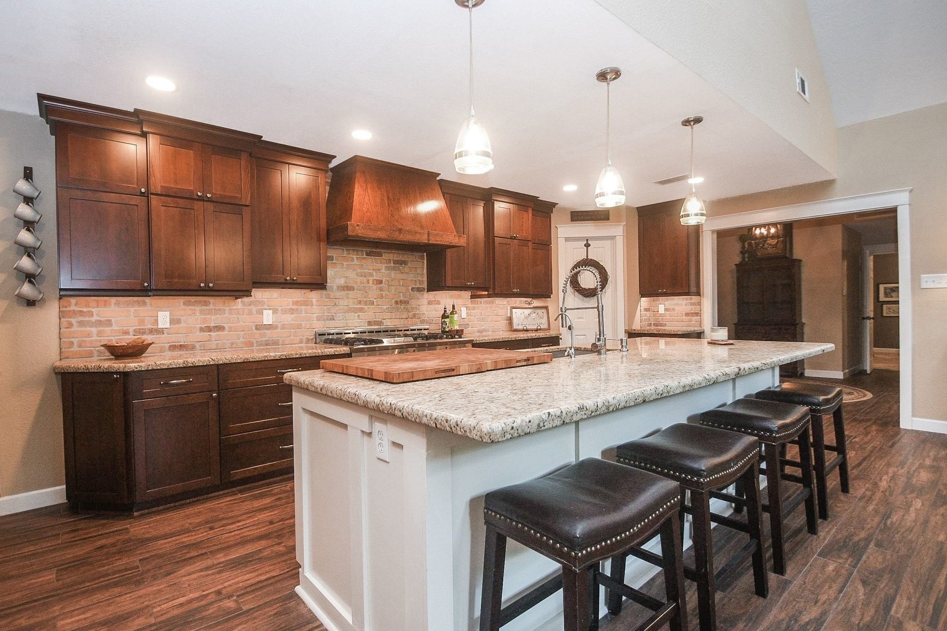 Open Island Kitchen with Custom Cabinets, a Professional NXP Pro 6-Burner Gas Range with Griddle & Large Walk-In Pantry. Large Utility Room.