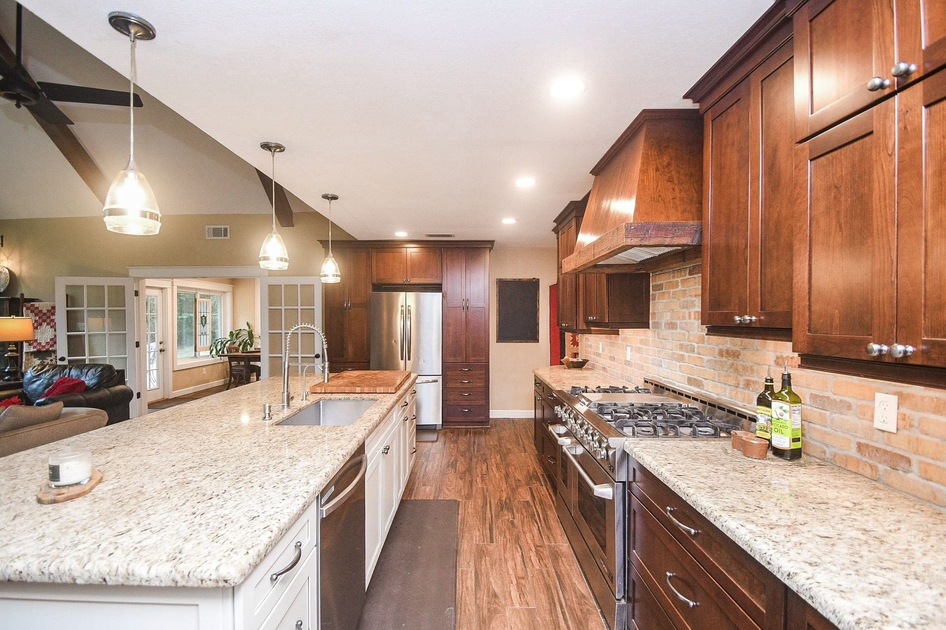 Open Island Kitchen with Custom Cabinets, a Professional NXP Pro 6-Burner Gas Range with Griddle & Large Walk-In Pantry. Large Utility Room.