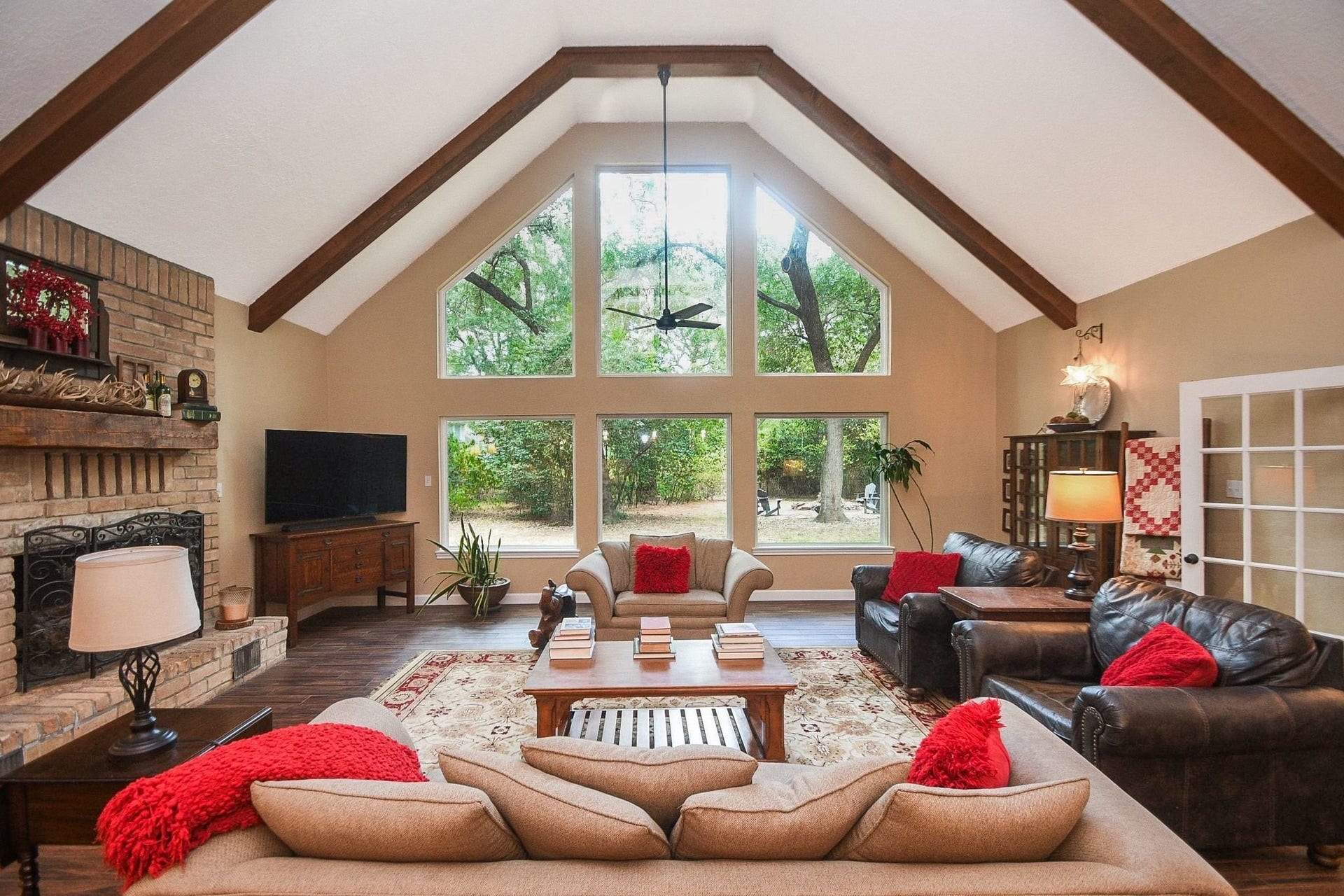 This Beautifully Updated Elegant Brick Home has an Over-Sized Living Area with High Ceilings, 2-Story Windows and a Brick-Faced Wood Burning Fireplace.