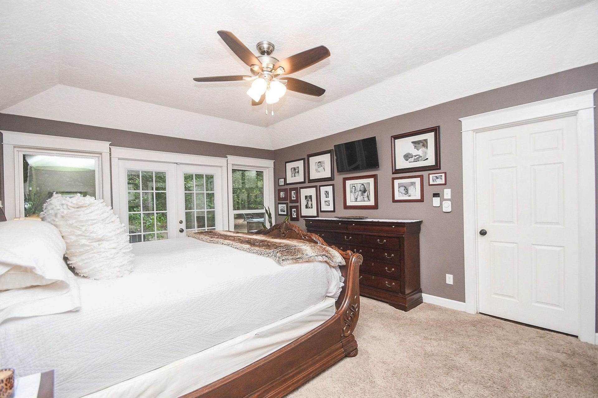 The Primary Bedroom has Double French Doors leading to the Back Yard Patio with Hot Tub.