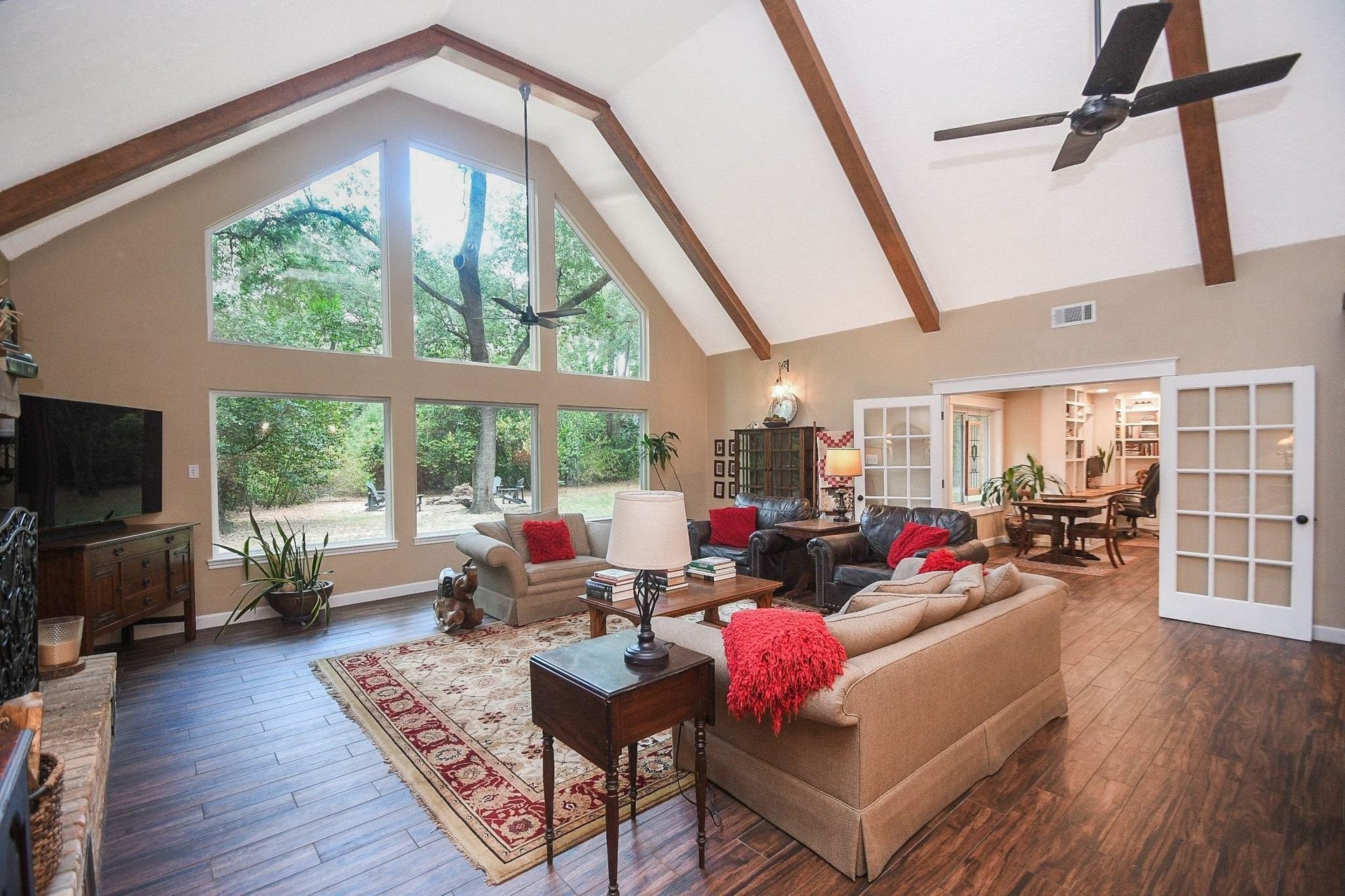 This Beautifully Updated Elegant Brick Home has an Over-Sized Living Area with High Ceilings, 2-Story Windows and a Brick-Faced Wood Burning Fireplace.