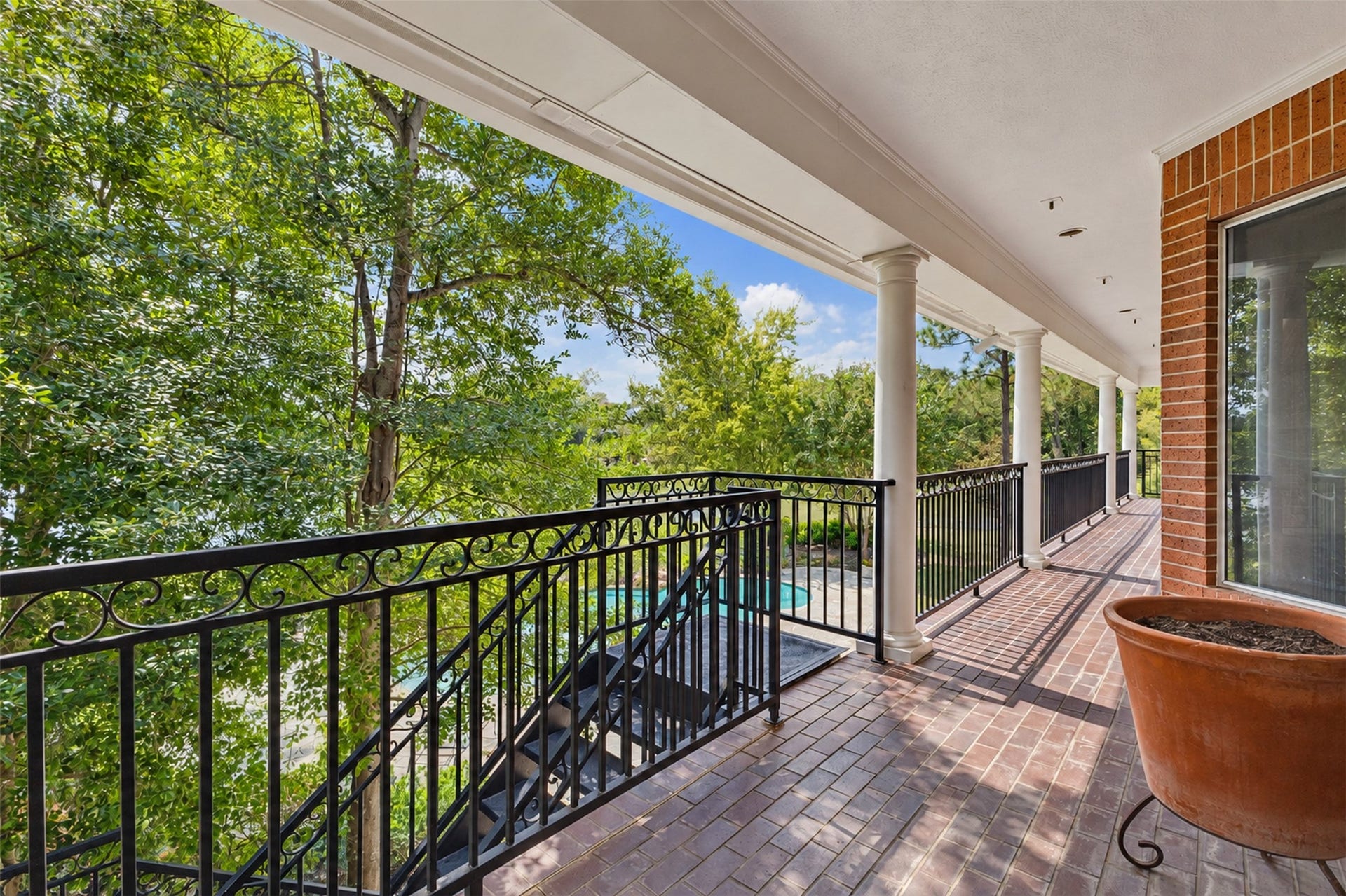 11602 haley hollow, Richmond, TX 77407 The second story balcony has a wrought iron staircase down to the patio.