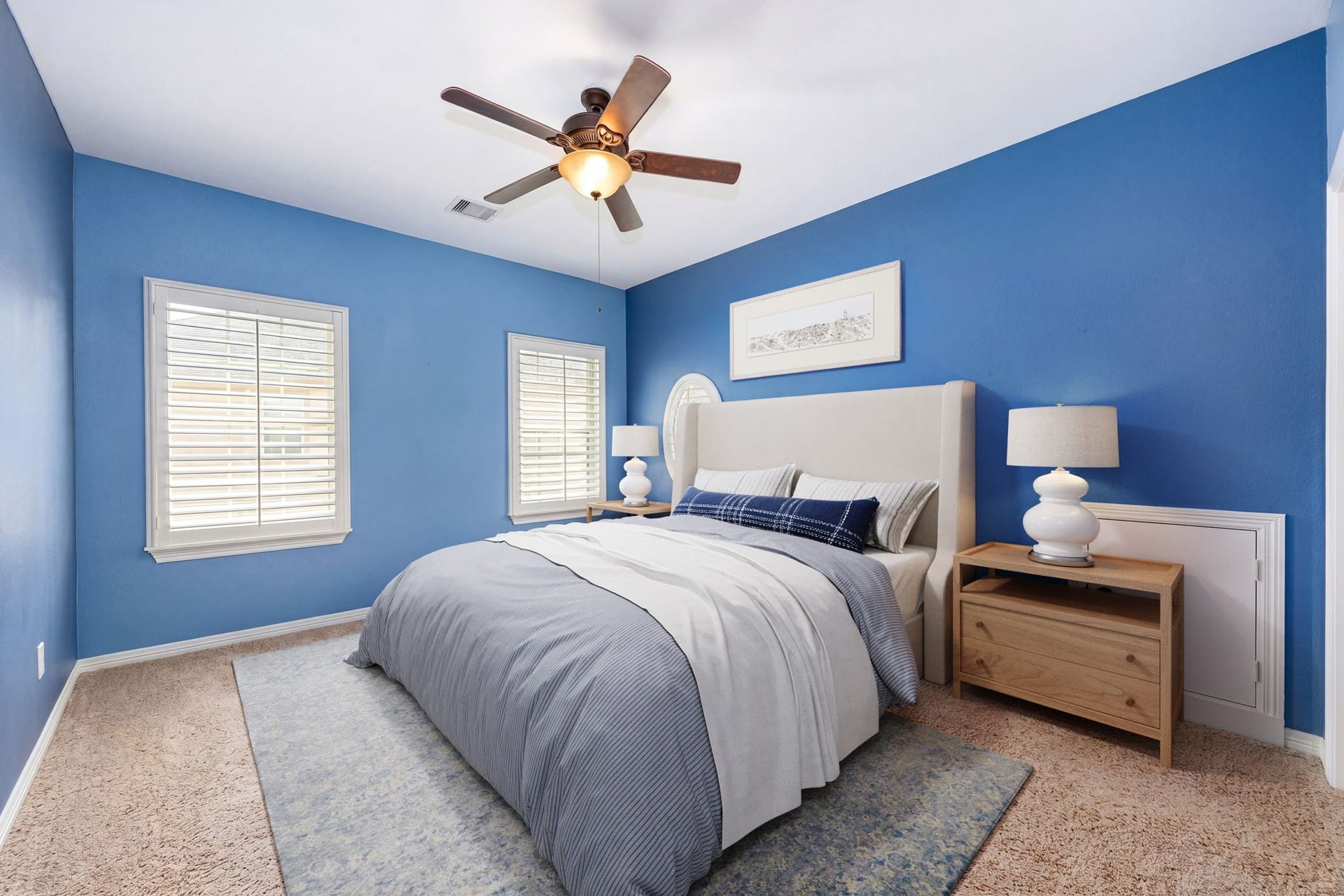 5102 Hawthorne Bend Drive, Katy, TX 77494 A bright and cheerful secondary bedroom featuring bold blue accent walls, plush carpet, plantation shutters, and a ceiling fan. The perfect space to personalize and make your own! *Virtually Staged