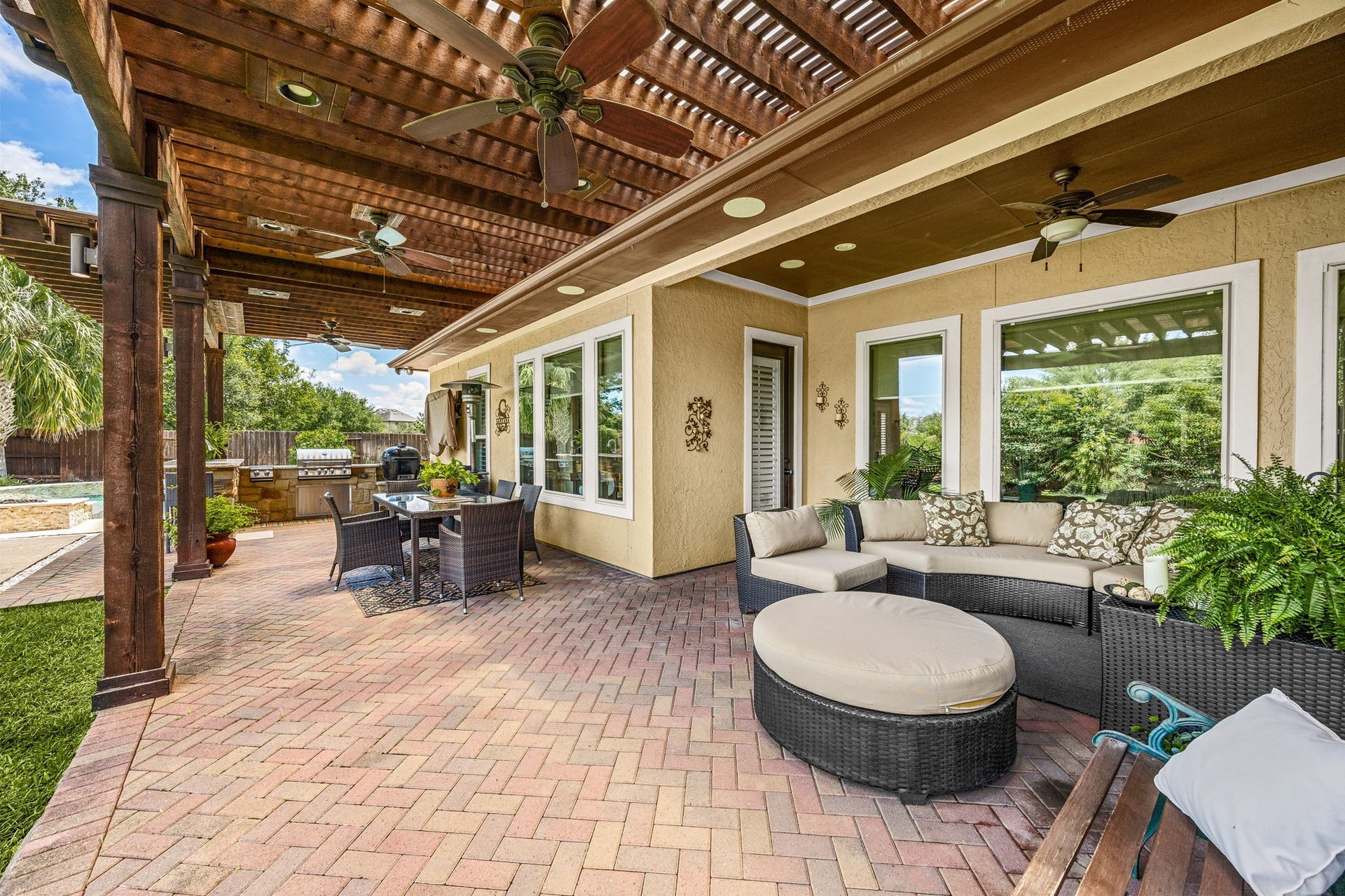 5102 Hawthorne Bend Drive, Katy, TX 77494 The ultimate outdoor living space! Dual ceiling fans, a sprawling brick paver patio, wood pergola, and lush tropical landscaping create a private oasis perfect for relaxing or entertaining all year long.