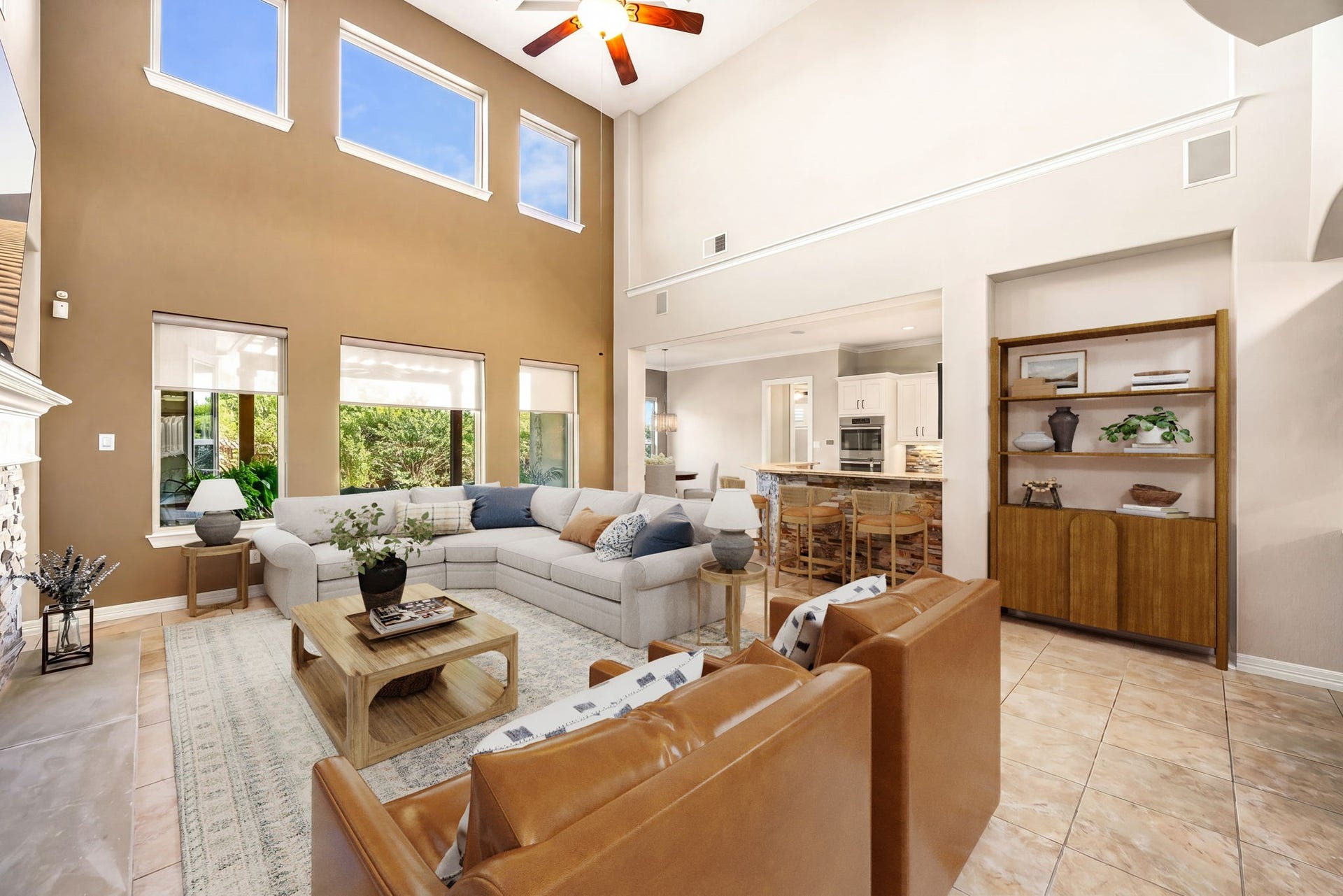 5102 Hawthorne Bend Drive, Katy, TX 77494 Cozy meets grand! This spacious living room features a dramatic stacked stone fireplace, built-in shelving, ceiling fan, wet bar, and soaring two-story ceilings, the ultimate space to relax and unwind. *Virtually Staged