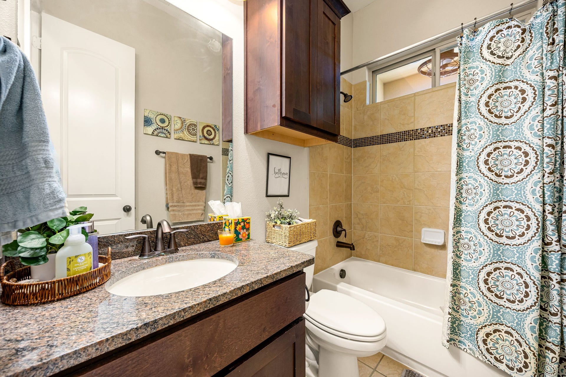 5102 Hawthorne Bend Drive, Katy, TX 77494 Cute and functional! This first floor bath features granite countertops, dark wood cabinetry, tile tub surround with mosaic accent, and plenty of storage.