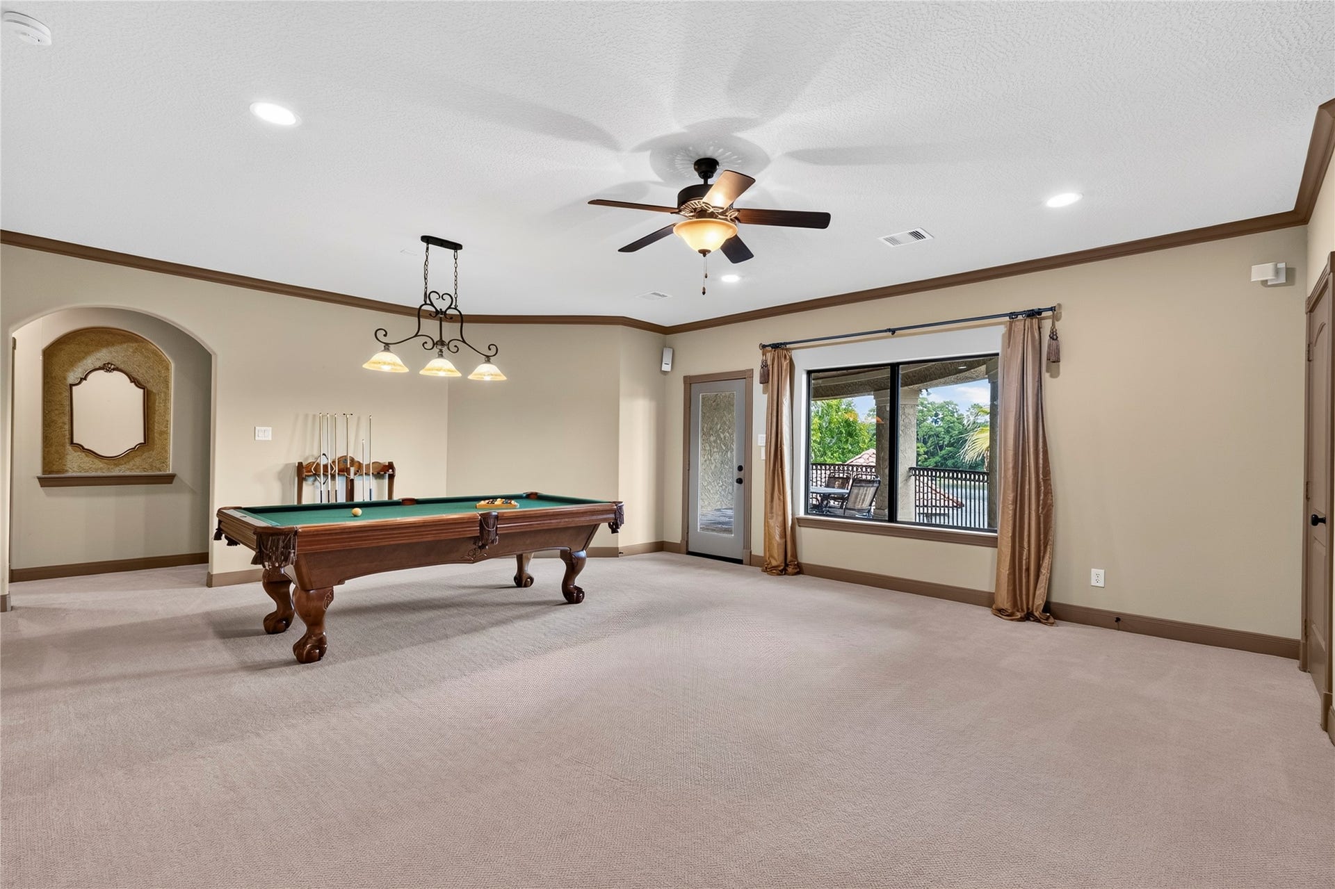 Huge upstairs game room covered balcony with sweeping views of the backyard, pond and golf course