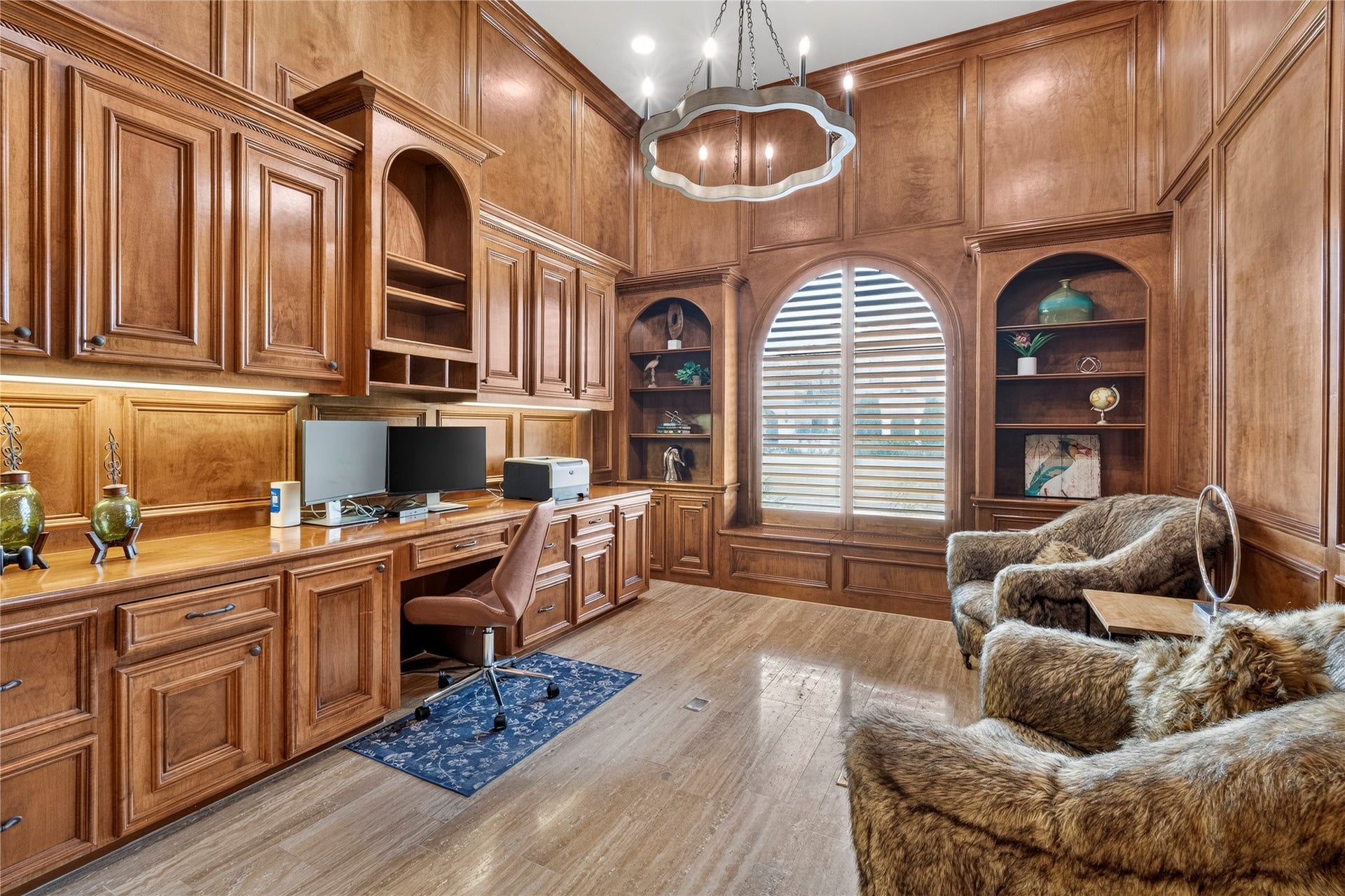 Home office with custom built in workstation and cabinetry, is at a mezzanine level off of the foyer