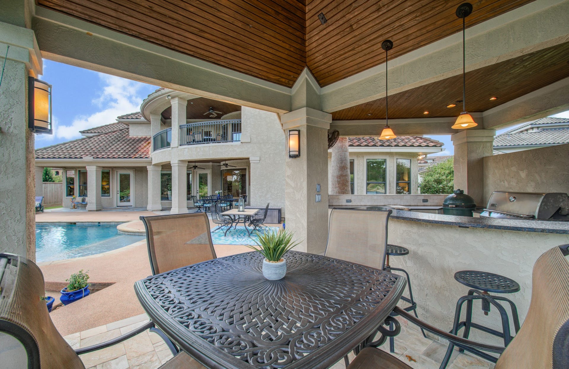 View of the house and backyard from the outdoor kitchen's dining area