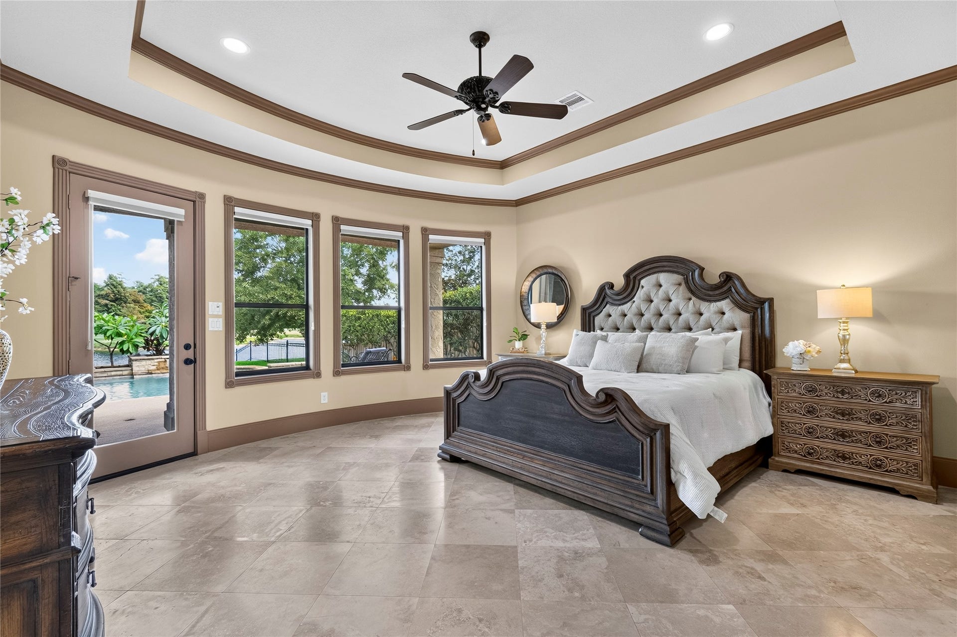 The owners suite is your private oasis.   Nestled away off of the foyer, this room includes a private entrance to the backyard and multiple windows for more views of the backyard and golf course.