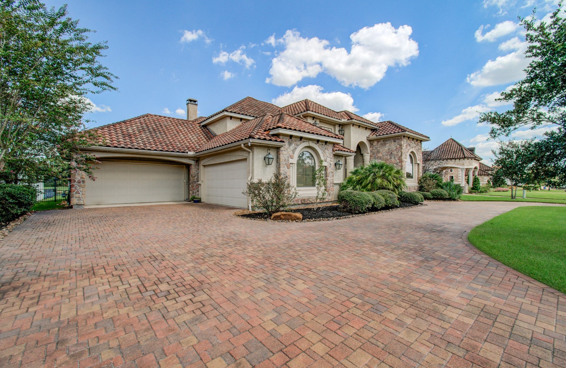 The two adjoining garages, which total four bays, are tucked away on the side of the house with a total of 4 bays.
