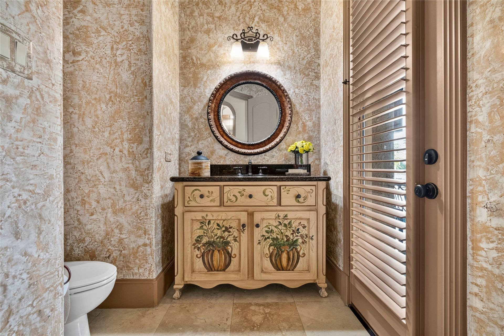 Downstairs powder room is also accessible from the backyard