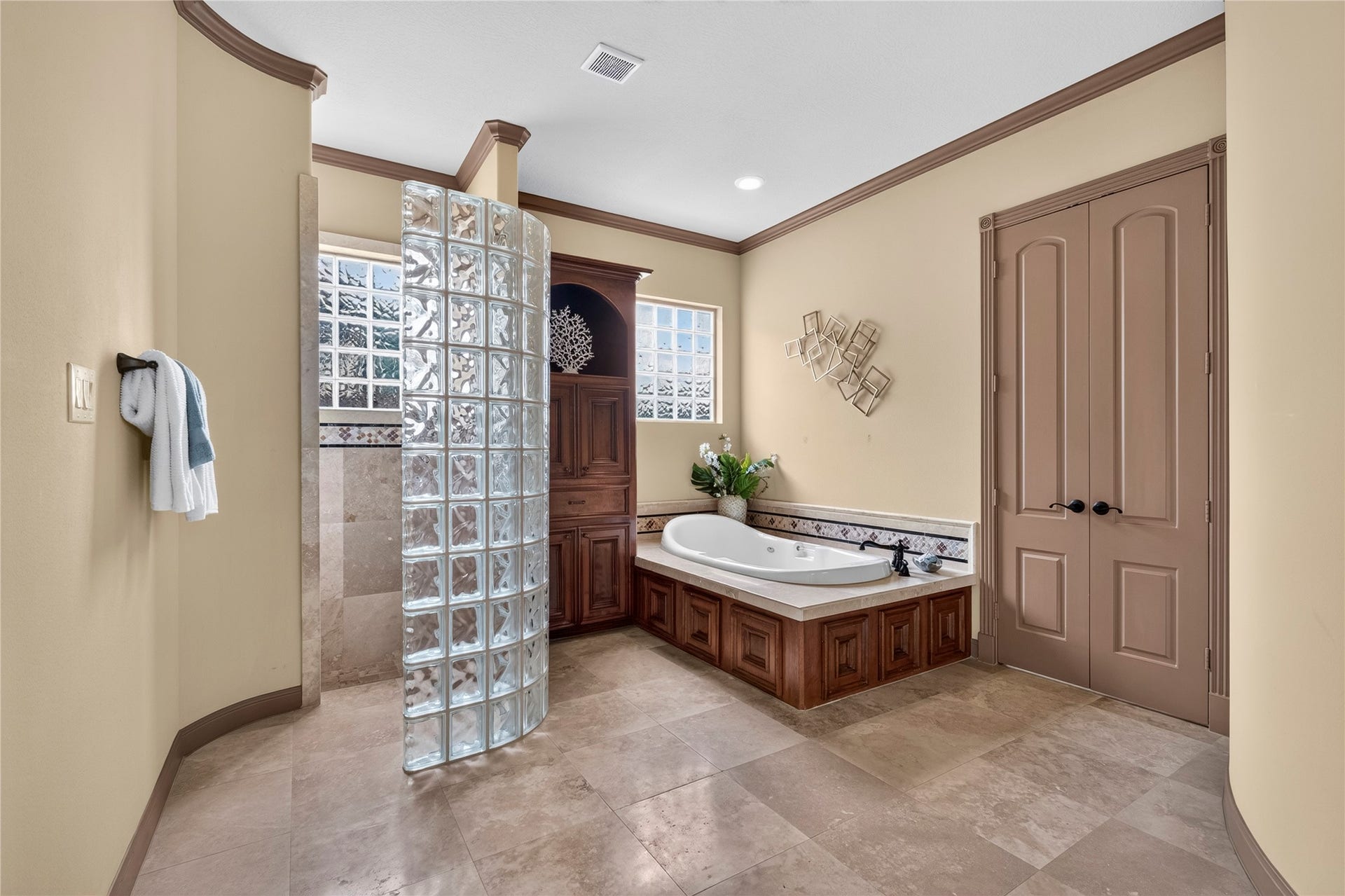 The primary bath includes a walk in shower and jetted tub