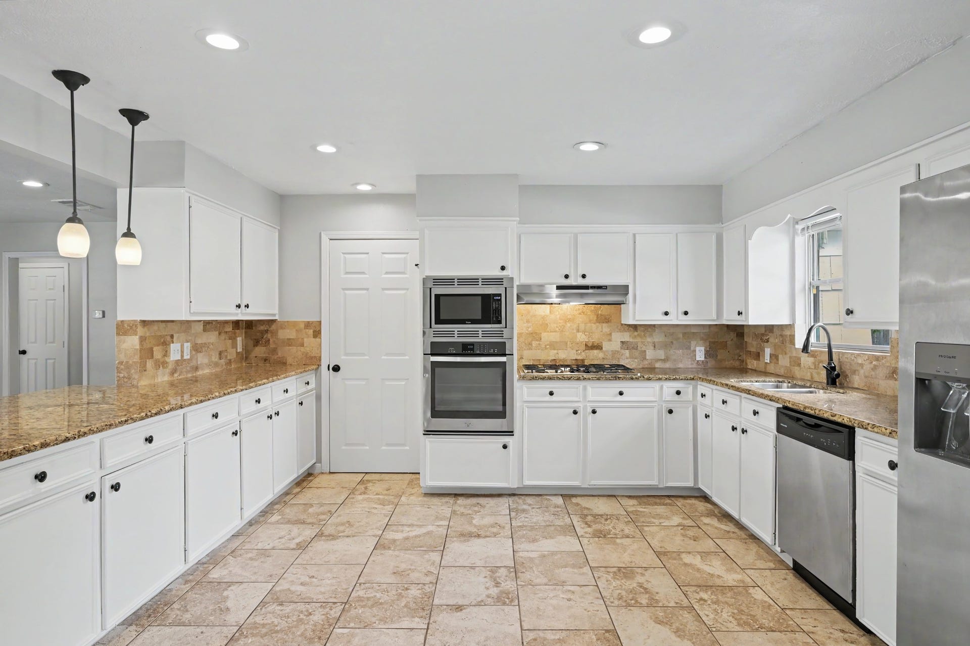 9613 Westview Drive, Houston, TX 77055 Kitchen features white painted cabinets, SS appliances, gas cooktop and granite countertops