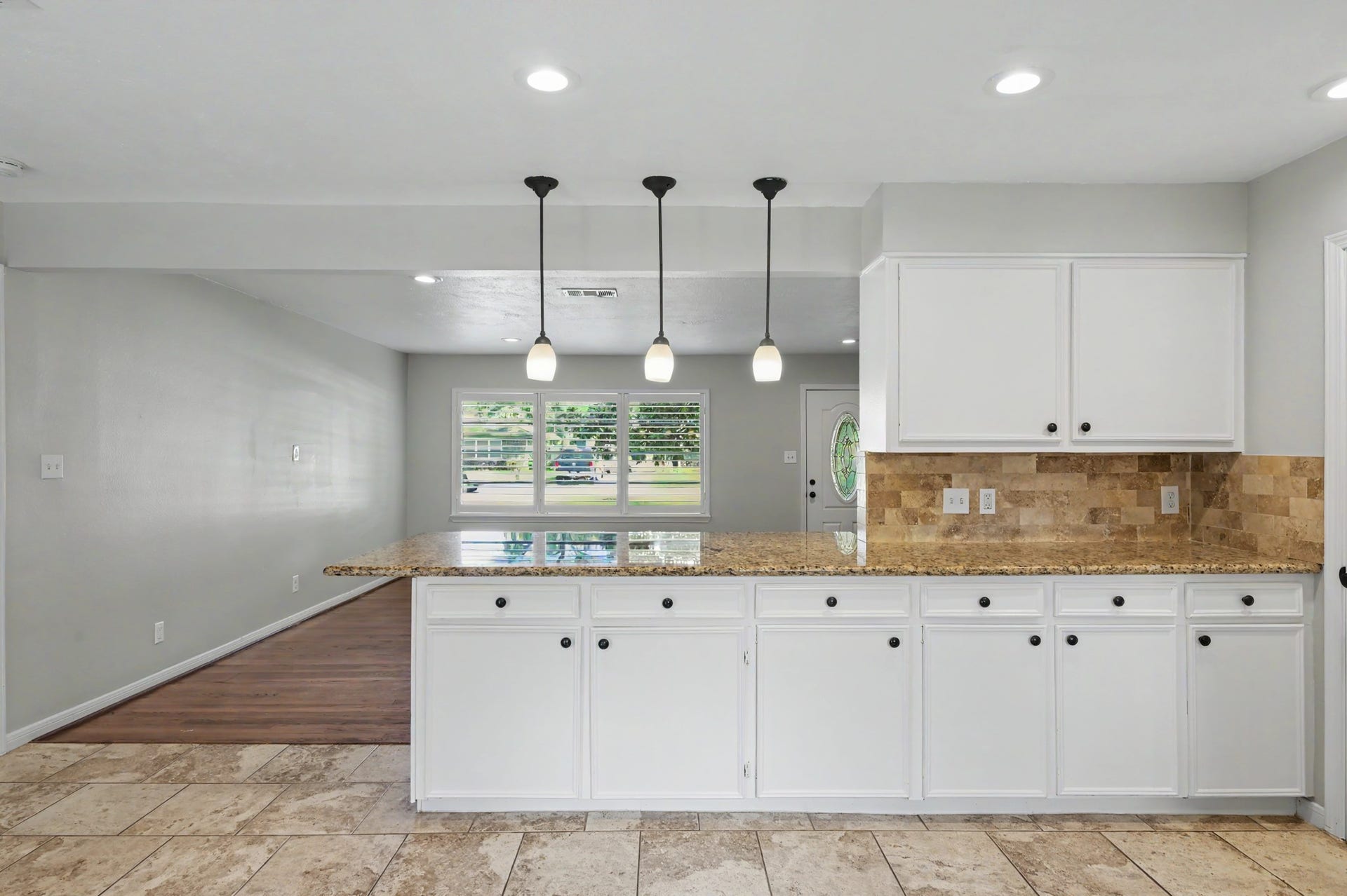 9613 Westview Drive, Houston, TX 77055 Kitchen w 3 charming pendant lights; tiled floors and tiled backsplash