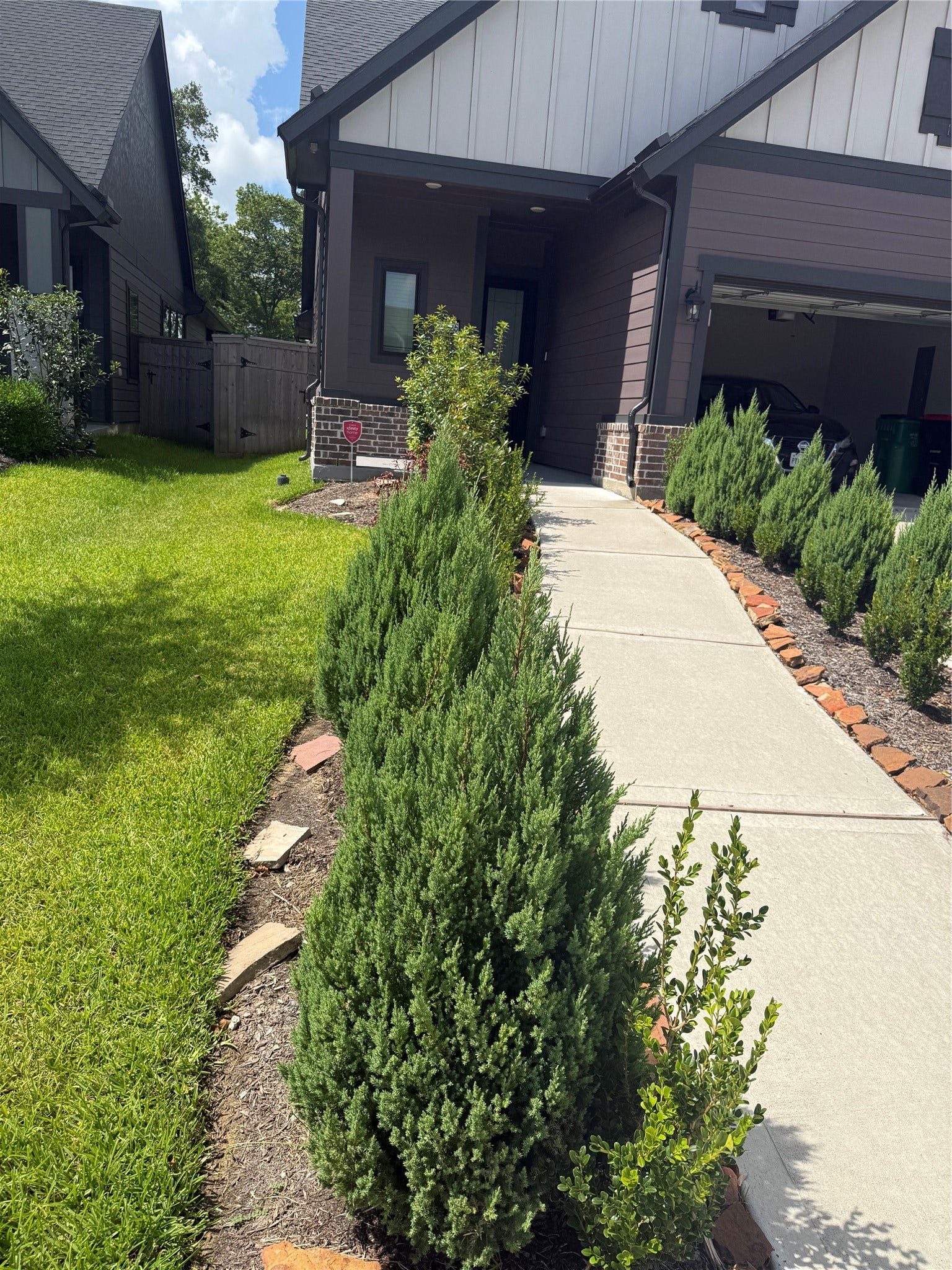 10526 William Park Drive, Missouri City, TX 77459 Charming home with a welcoming front path lined by lush greenery, leading to a cozy porch and garage.