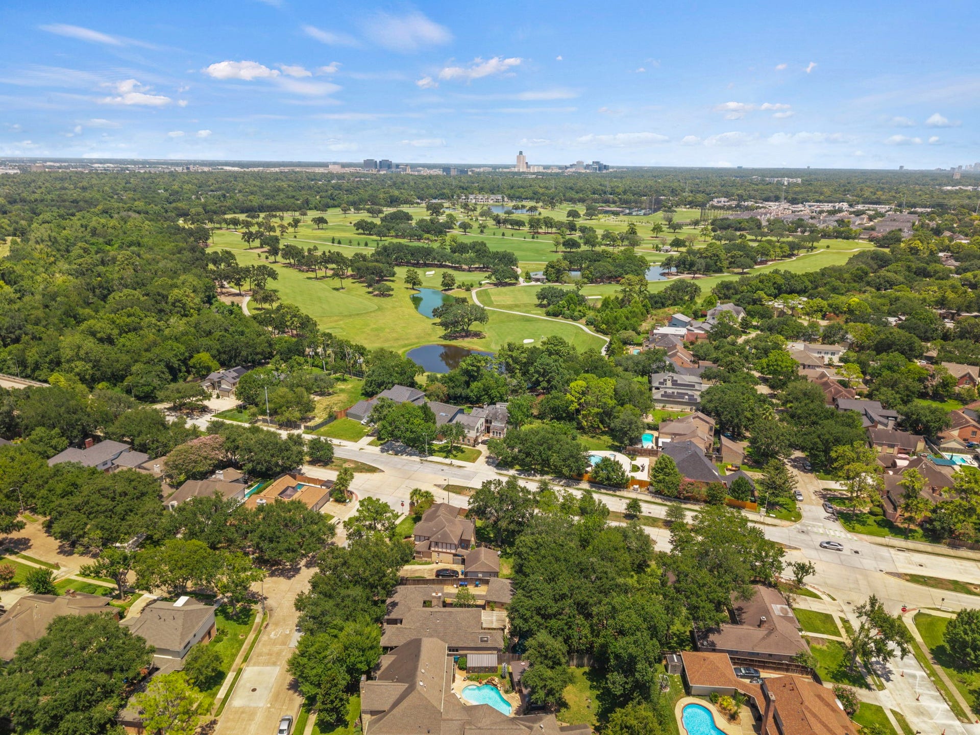11807 Carriage Hill Drive, Houston, TX 77077 The aerial view captures the homes Energy Corridor setting, mature surroundings, and proximity to green space. It gives context to the propertys location near Terry Hershey Park and the surrounding Woods Lakeside area.