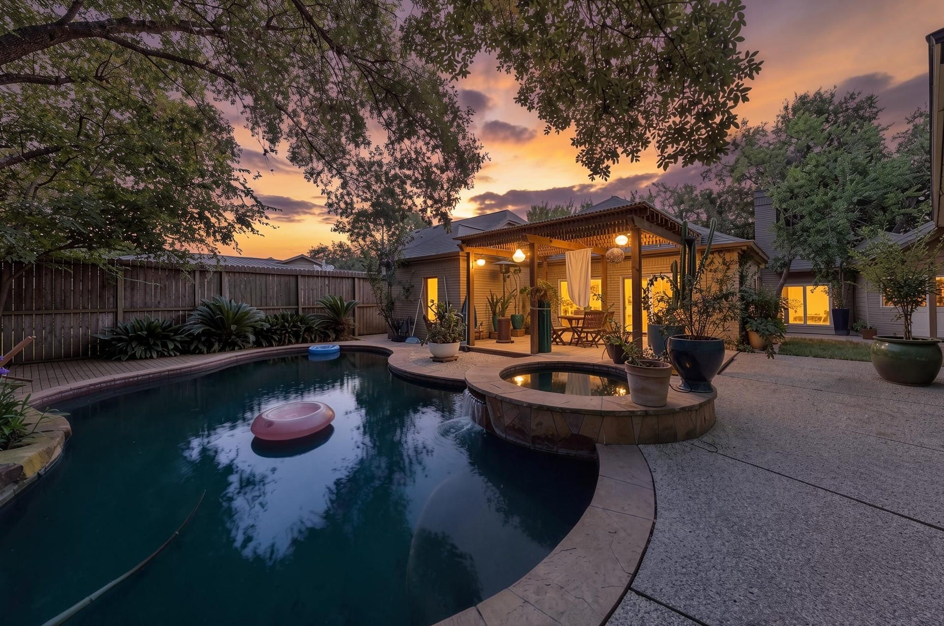 11807 Carriage Hill Drive, Houston, TX 77077 The backyard pool creates a private retreat with a shaded setting, attached hot tub, and mature landscaping surrounding the space. The evening view gives the outdoor area a calm, resort-style presence. - Virtually enhanced