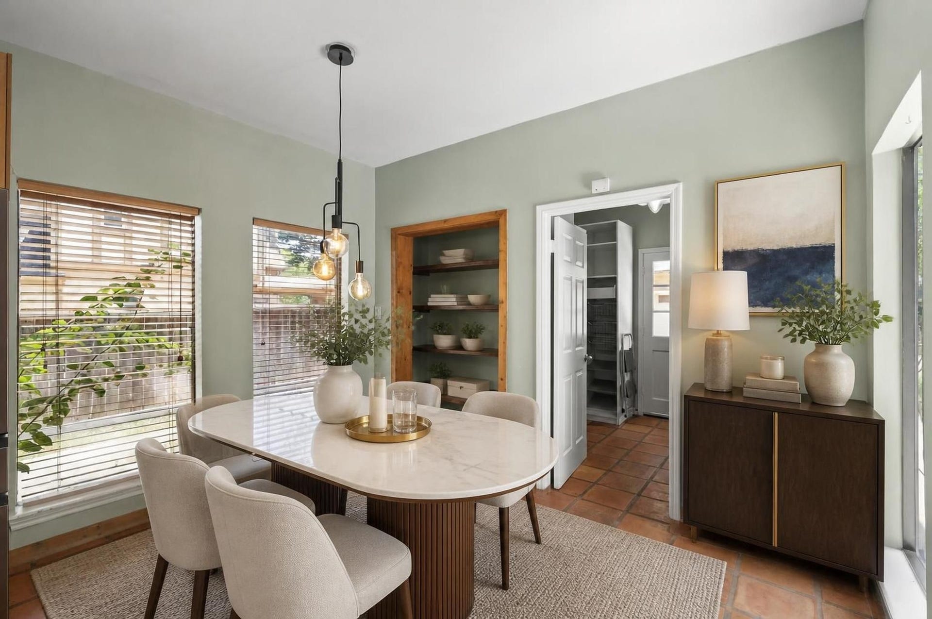 11807 Carriage Hill Drive, Houston, TX 77077 The breakfast area sits near the kitchen with backyard views and easy access to the patio spaces. It creates a bright everyday dining area separate from the formal dining room. Virtually staged.
